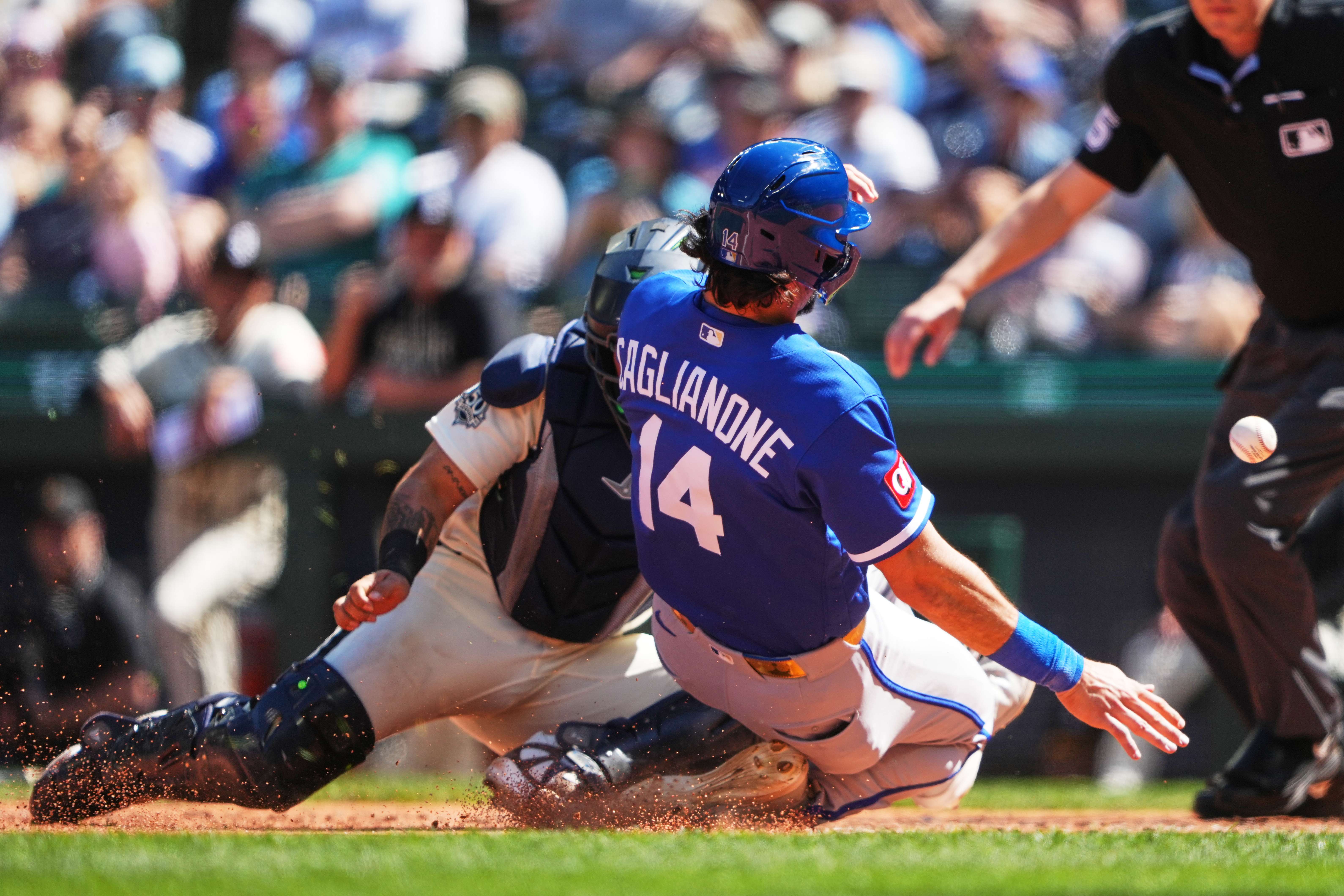 Kansas City Royals' Jac Caglianone scores on an RBI double from Isaac Collins in front of Seattle Mariners catcher Jhonny Pereda during the sixth inning of a baseball game, Sunday, May 3, 2026, in Seattle. (AP Photo/Lindsey Wasson)