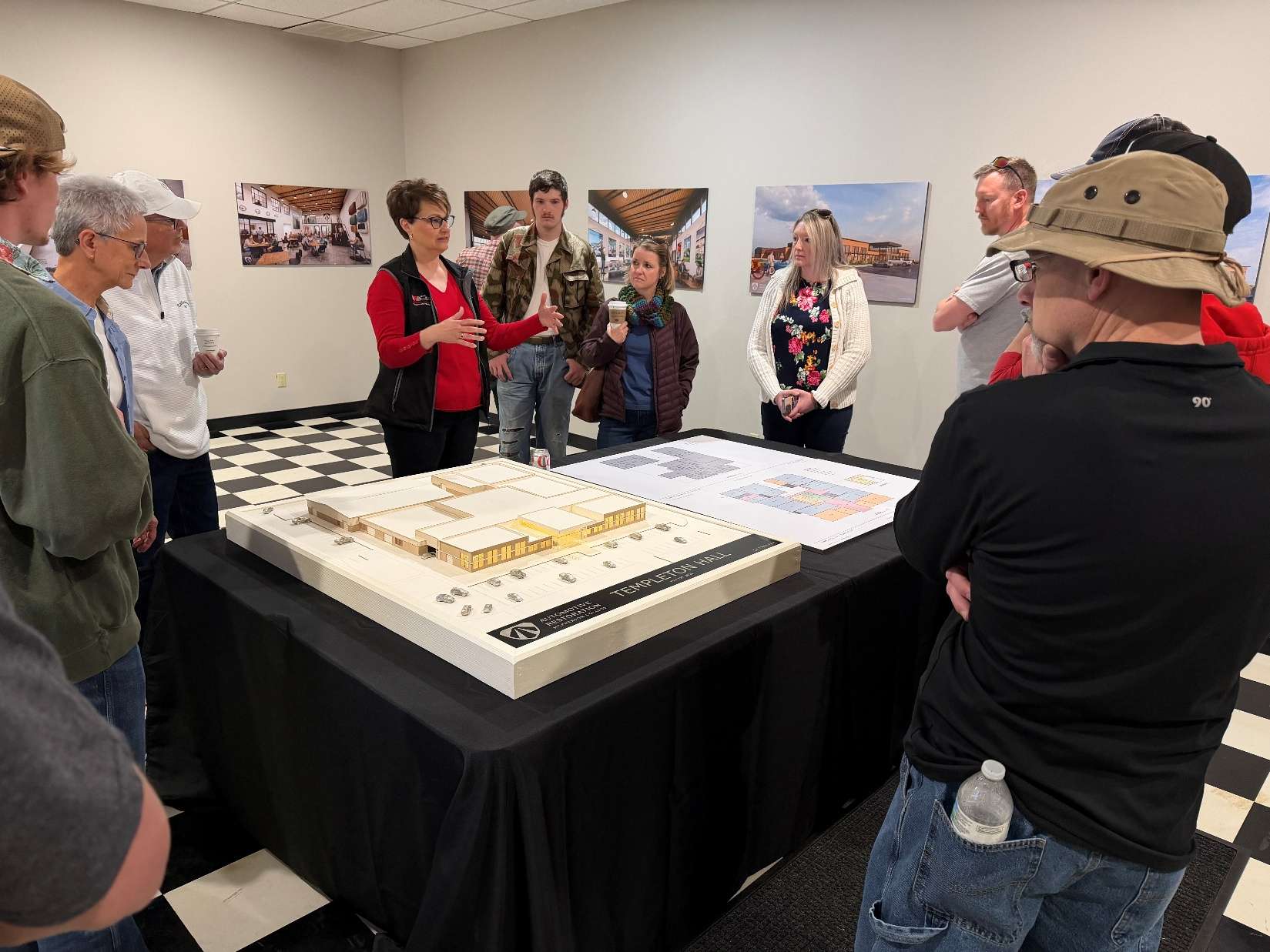 Amanda Gutierrez, vice president for automotive restoration, explains the new plans for Templeton Hall to visitors during the annual C.A.R.S. Club Motoring Festival at McPherson College. (Photo courtesy McPherson College)