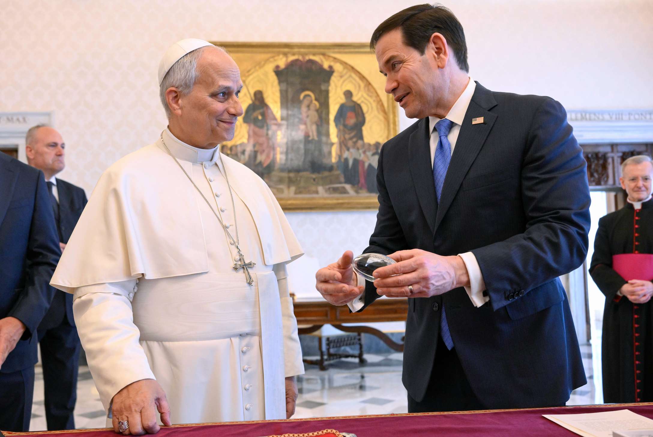 In this handout photo provided by Vatican Media Pope Leo XIV exchanges gifts with U.S. Secretary of State Marco Rubio, right, as they meet in the pope's private library at the Vatican, Thursday, May 7, 2026. (Vatican Media via AP)