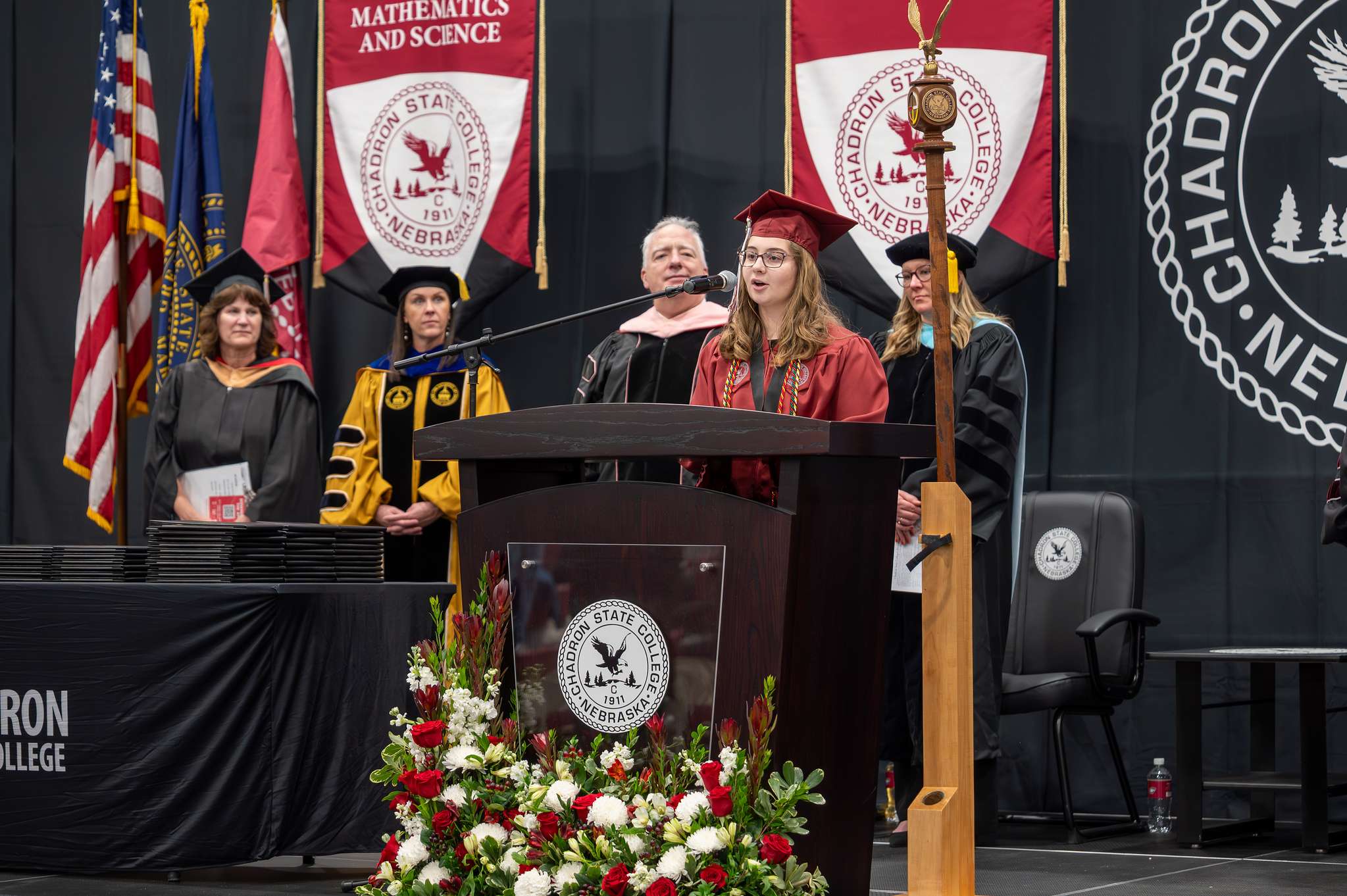 Bachelor of Science Degree Candidate Ellieigh Fisher presents the opening moment of reflection during the 2025 Winter Commencement ceremony in the Chicoine Center, Dec. 12, 2025. (Photo by Sydney Brown/Chadron State College)