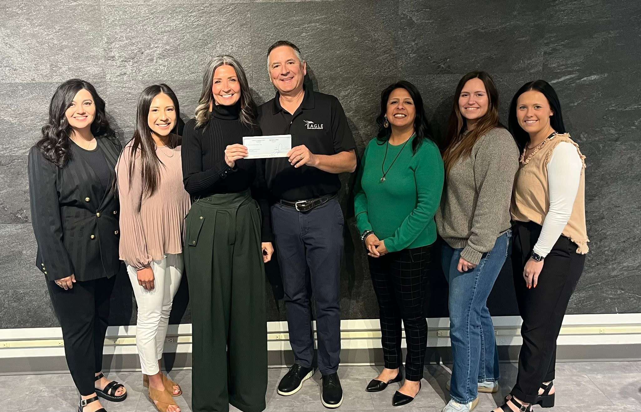 Lewys Carlini presents a $10,000 donation from Eagle Media and the Schmidt Foundation to Holly Carlini, executive director of the Prairie Arts Center, during North Platte Giving Day. Prairie Arts Center raised a total of $77,730 from 34 donors during the community fundraising event.