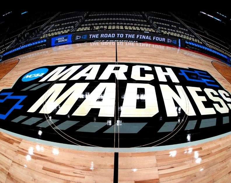 March Madness logo is displayed at center court during the opening rounds of the NCAA college basketball tournament in Pittsburgh, Wednesday, March 20, 2024. (AP Photo/Gene J. Puskar, File)