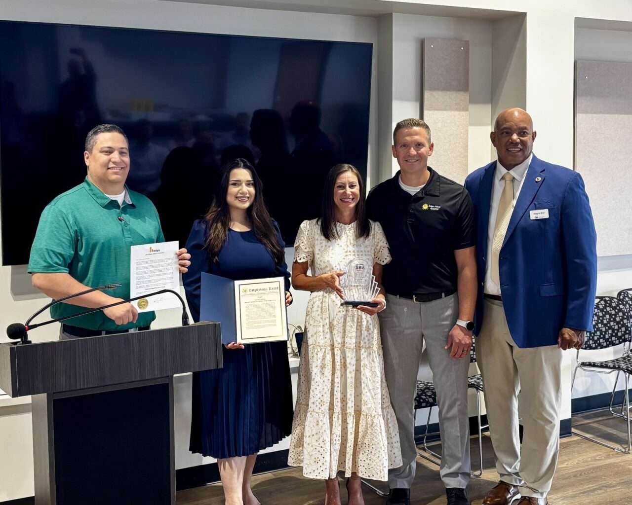 Bright Minds Academy in Hays co-Founders Andrea and Nick Felder with their National Small Business Week award alongside Mayor Mason Ruder, a representative from&nbsp;Sen. Roger Marshall's office. and Small Business Administration district director&nbsp;Wayne Bell. Photo by Tony Guerrero/Hays Post
