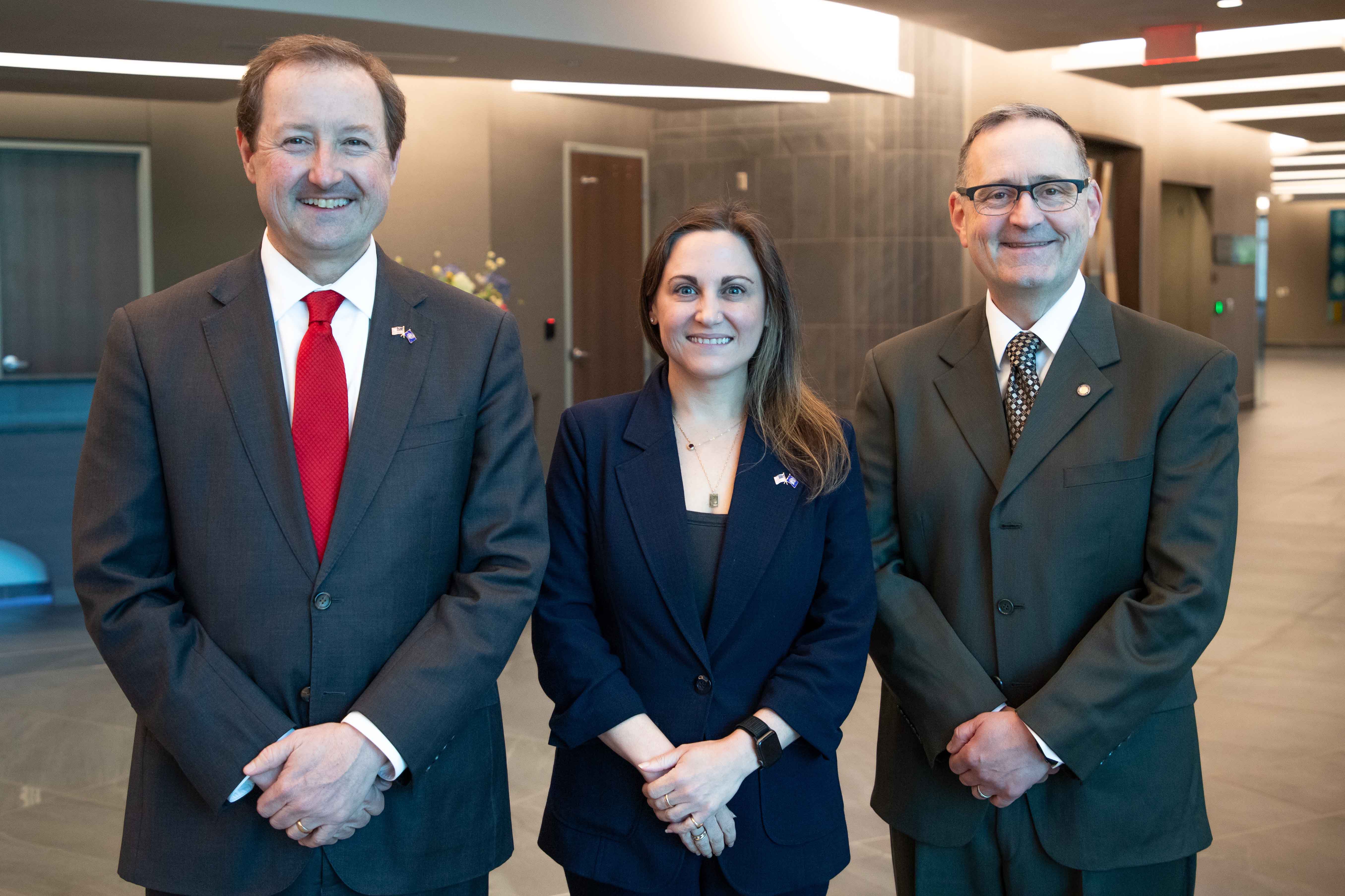 From left, Chris Kratochvil, MD, vice chancellor of external relations for UNMC, Lauren Sauer, PhD, associate professor in the UNMC College of Public Health and associate director of research at the Global Center for Health Security and Col. Lee Williames (USAF, Ret.), MD, inaugural director of the Office for the Advancement of Military Medicine. (Rich Watson/UNMC)