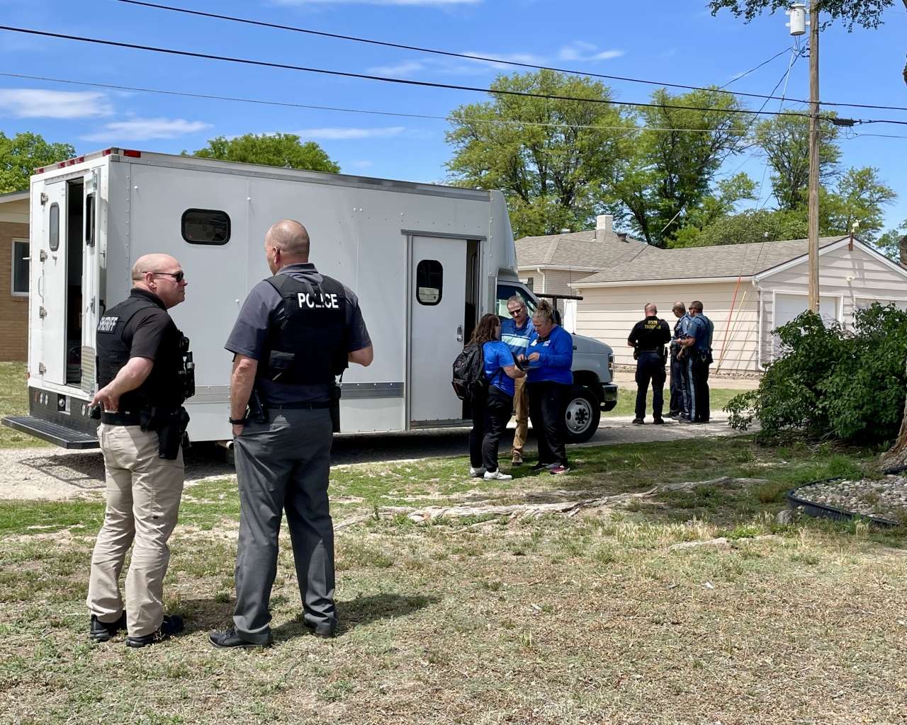 Law enforcement and High Plains Mental Health Center staff in the area of 24th and Fort Street. Photo by Becky Kiser/Hays Post