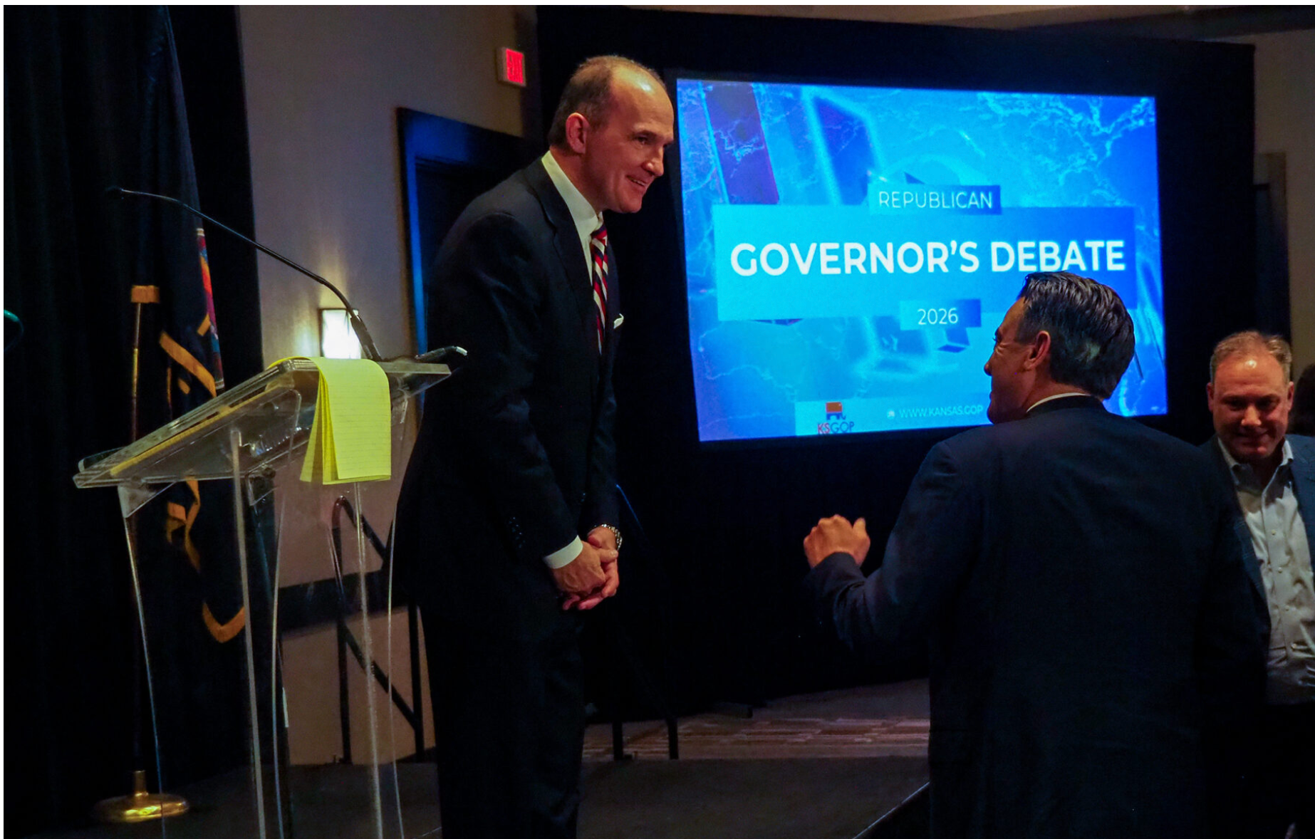  Republican gubernatorial candidate Philip Sarnecki, who wants the Kansas Legislature to convene in special session to address rising property taxes, chats with former U.S. Rep. Kevin Yoder during a Jan. 30, 2026, GOP candidate forum in Wichita. (Photo by Tim Carpenter/Kansas Reflector)