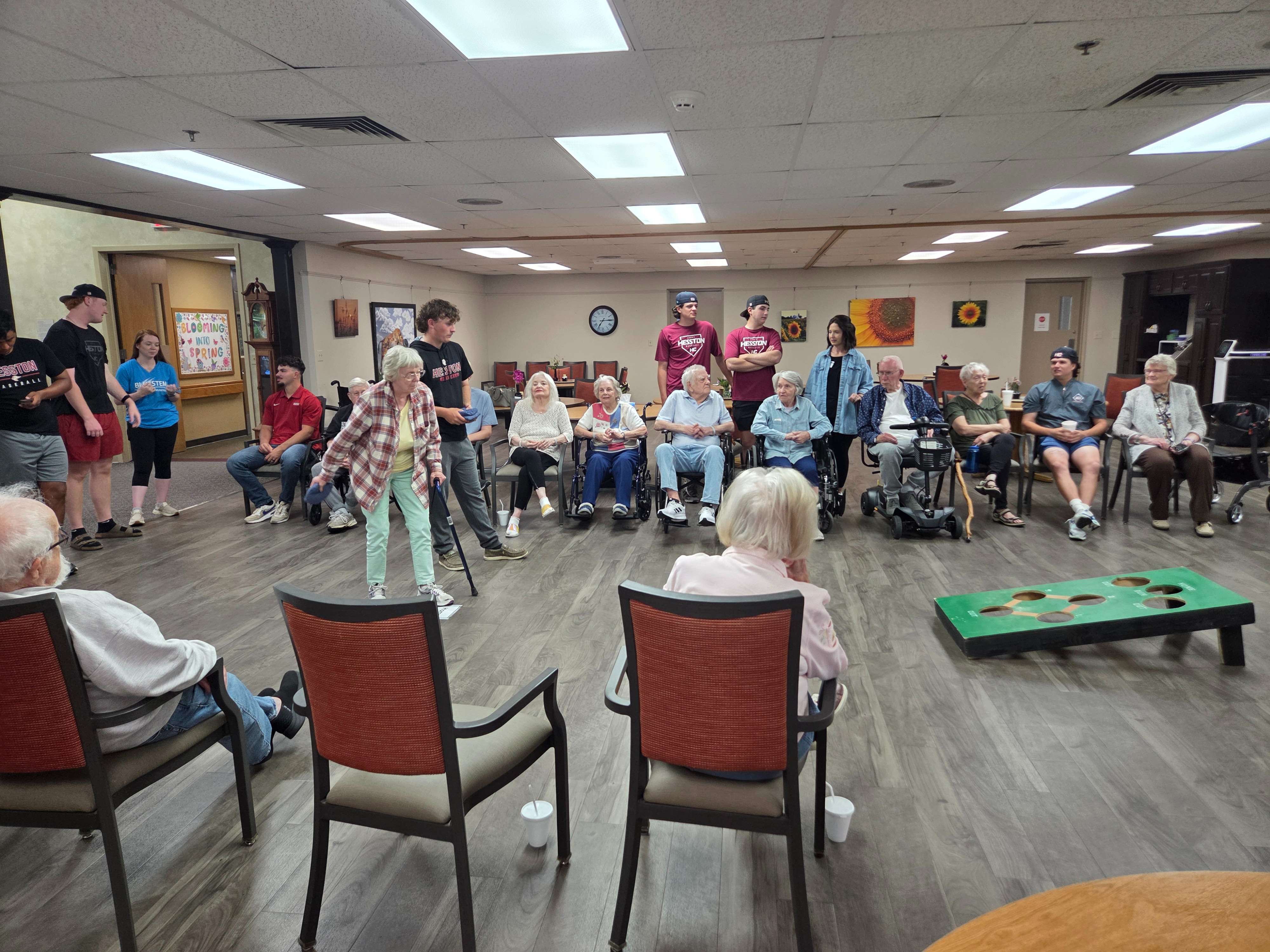 Schowalter Villa residents and Hesston College baseball players enjoy a game of Beanbag Baseball. The two groups met every Monday evening throughout the school year to connect with one another and build community. (Photo courtesy Bluestem Comminities)
