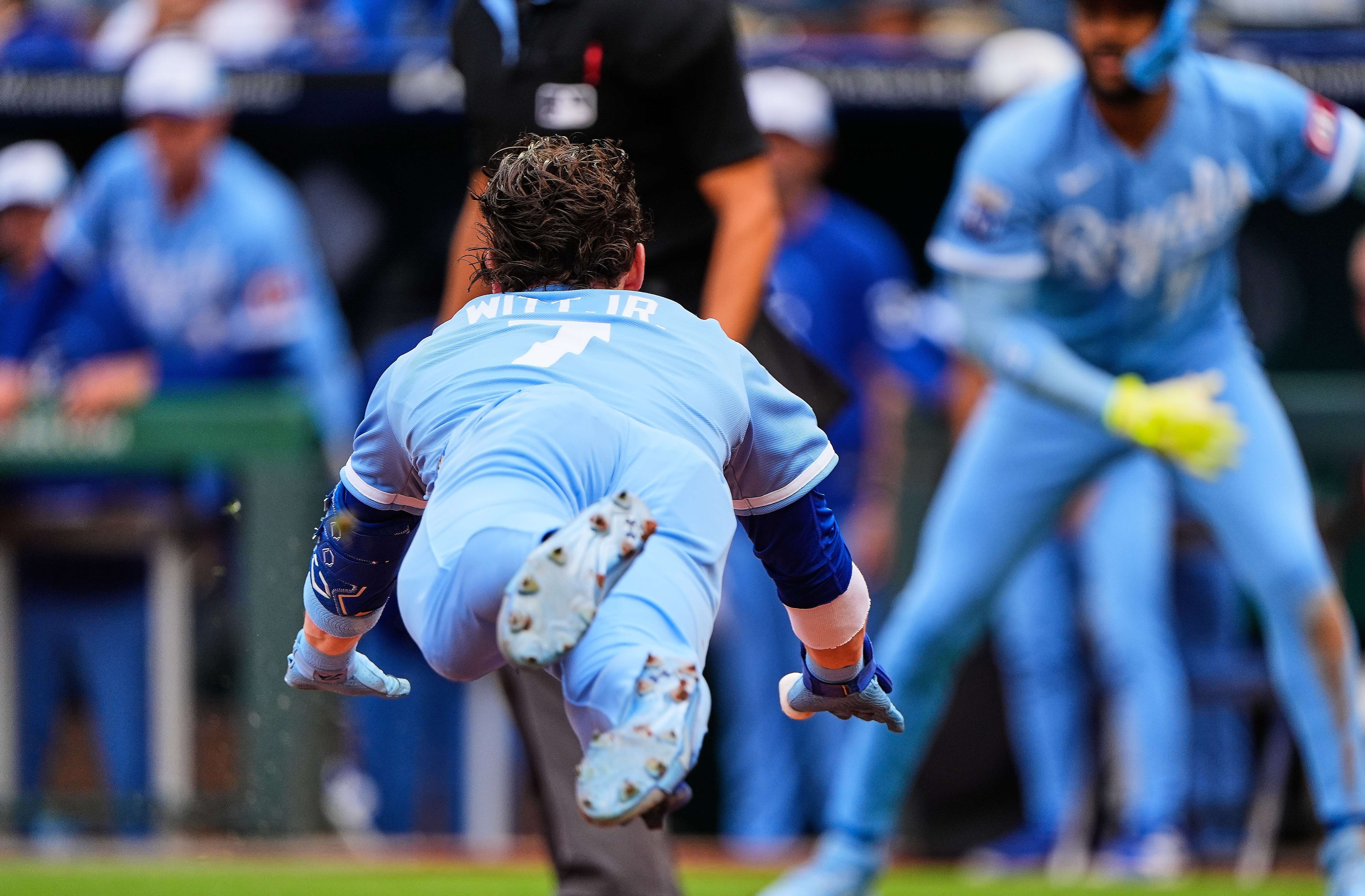 Kansas City Royals' Bobby Witt Jr. dives home to score after hitting a inside-the-park home run during the first inning of a baseball game against the Detroit Tigers, Saturday, May 9, 2026, in Kansas City, Mo. (AP Photo/Charlie Riedel)