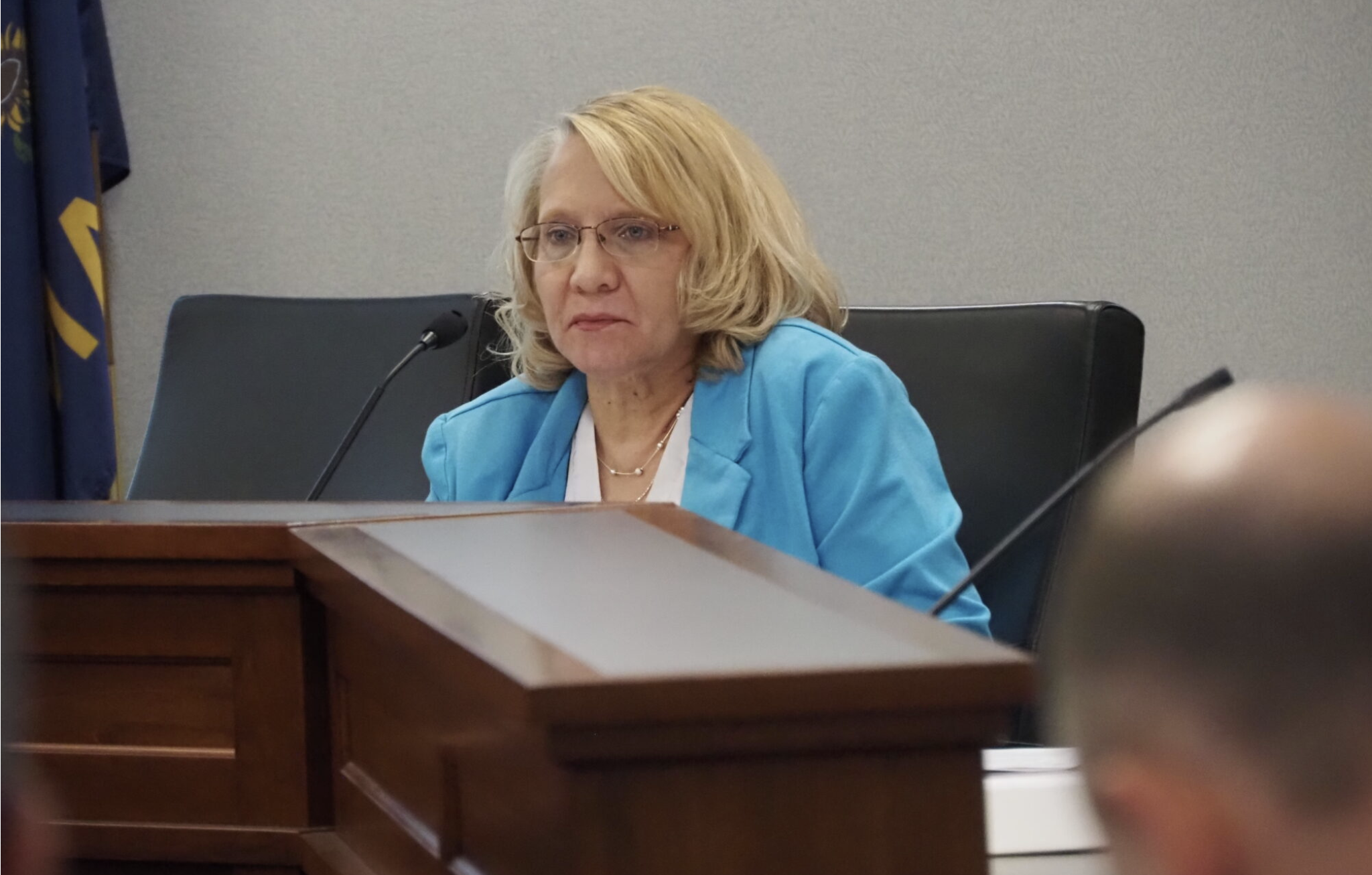  Cristi Cain, who serves as the state employee representative on the Kansas State Employees Health Care Commission, shares stories and opinions on May 11, 2026, from numerous employees who reached out to her about health insurance. (Photo by Morgan Chilson/Kansas Reflector)