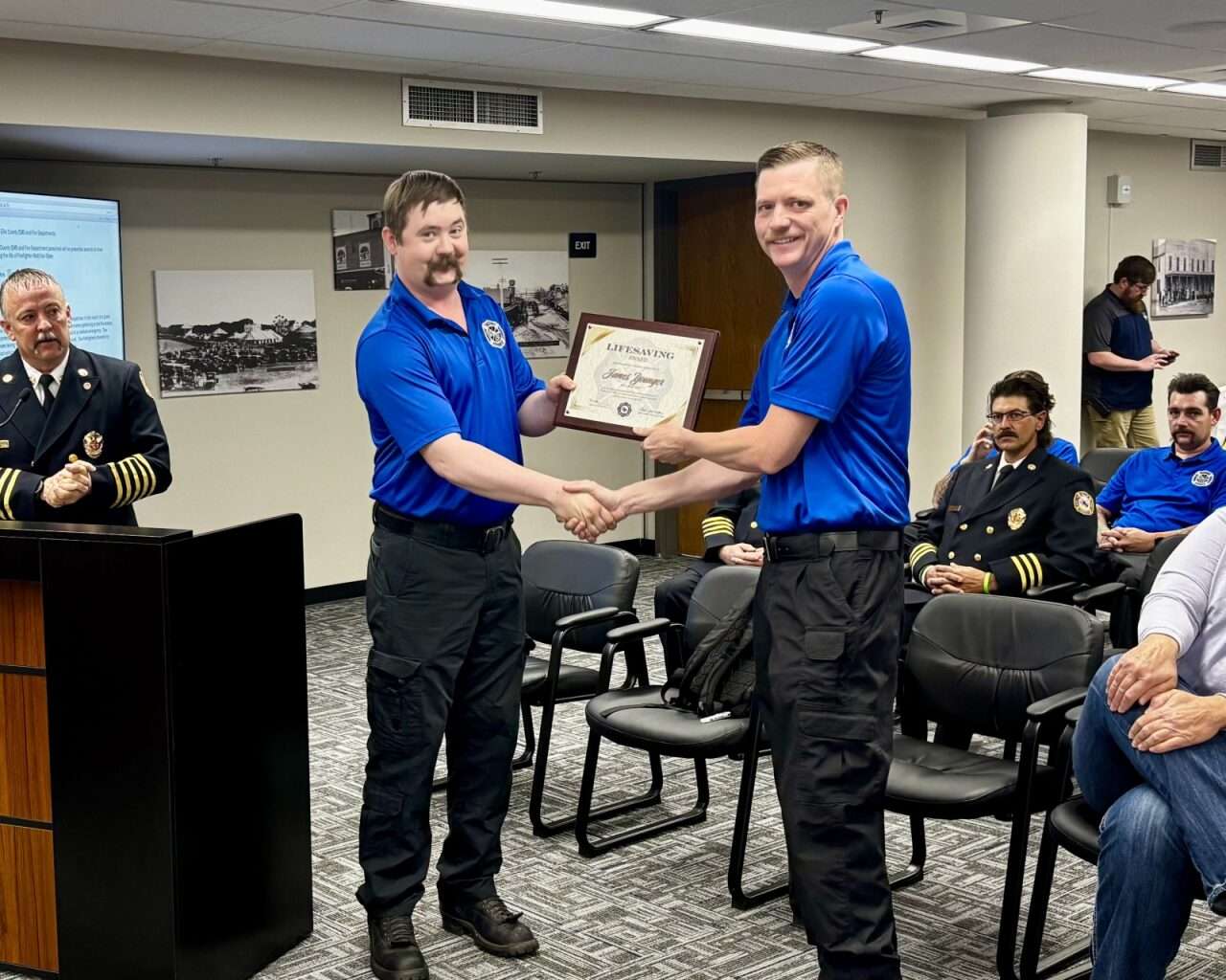 Firefighter Matt VanDyke handing Capt. James Younger a&nbsp;Lifesaving Commendation Award. Photo by Tony Guerrero/Hays Post