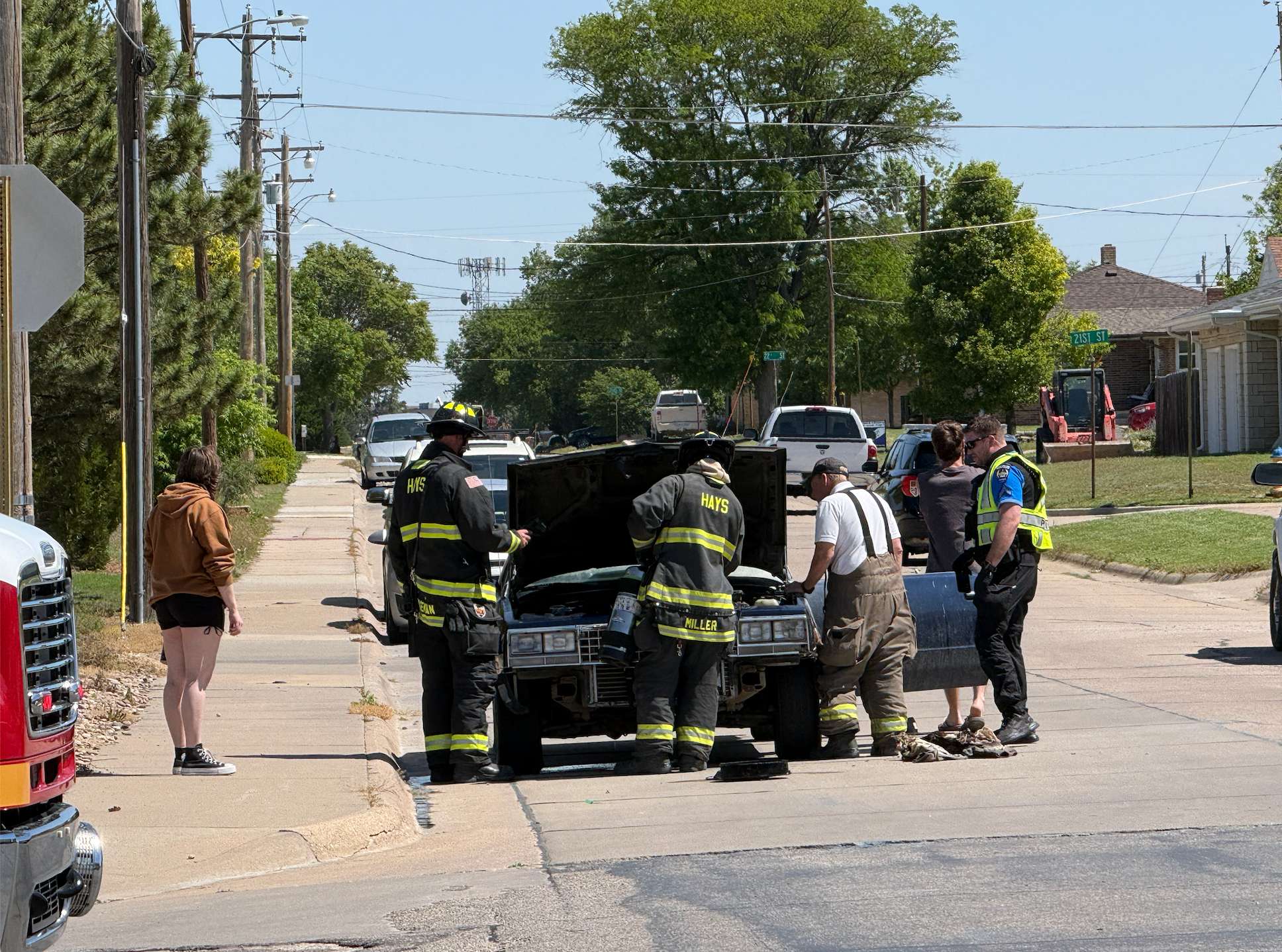 Hays Fire Department personnel investigate the cause of a vehicle fire at 20th and Oak today. Photo by Cristina Janney/Hays Post