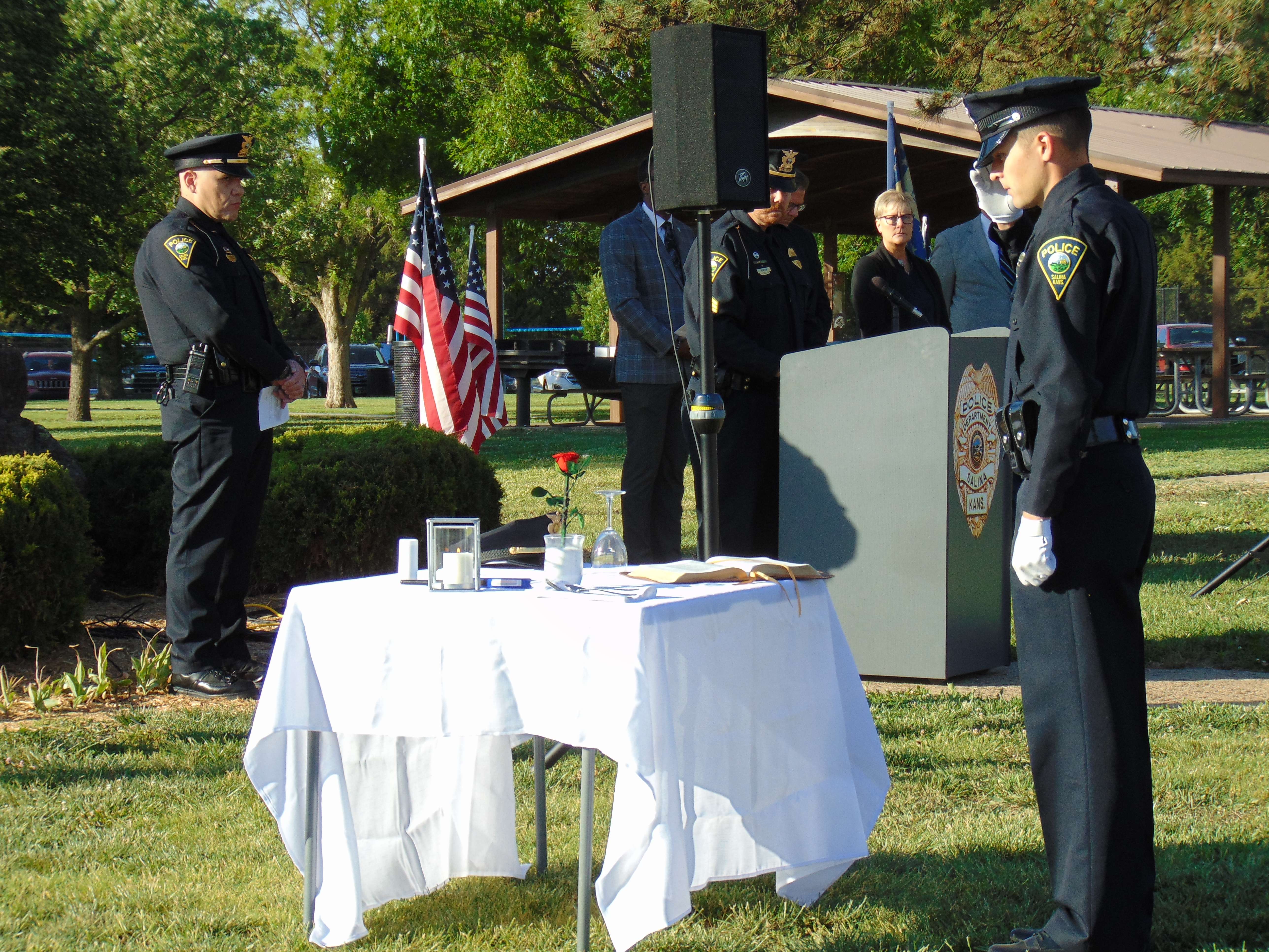 Salina Police Officer honors the fallen after setting up the Fallen First Responder table - Photo, Nicolas Fierro