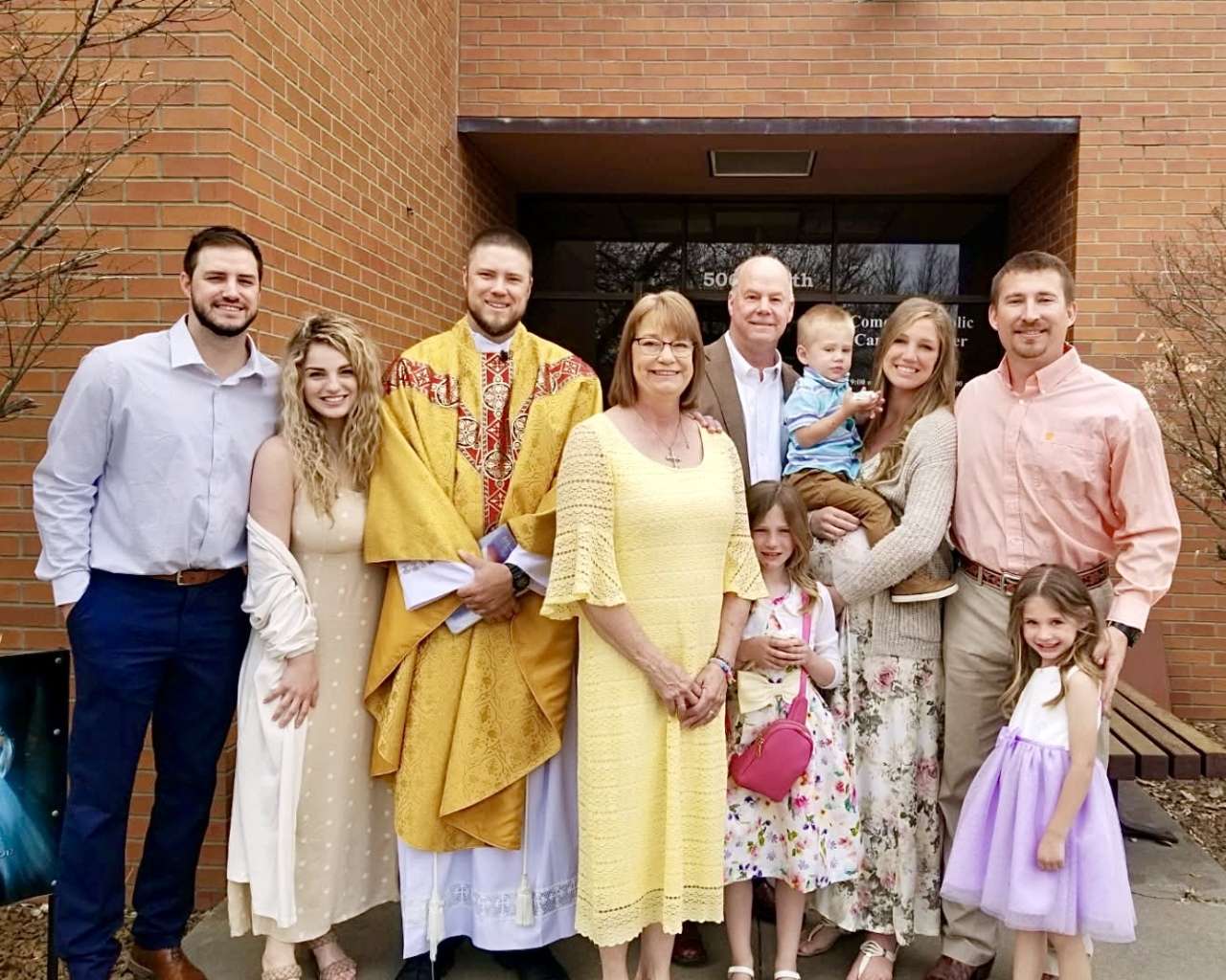 The Rev. Andy Hammeke with his family in front of the Comeau Catholic Campus Center at Fort Hays State University. Courtesy photo