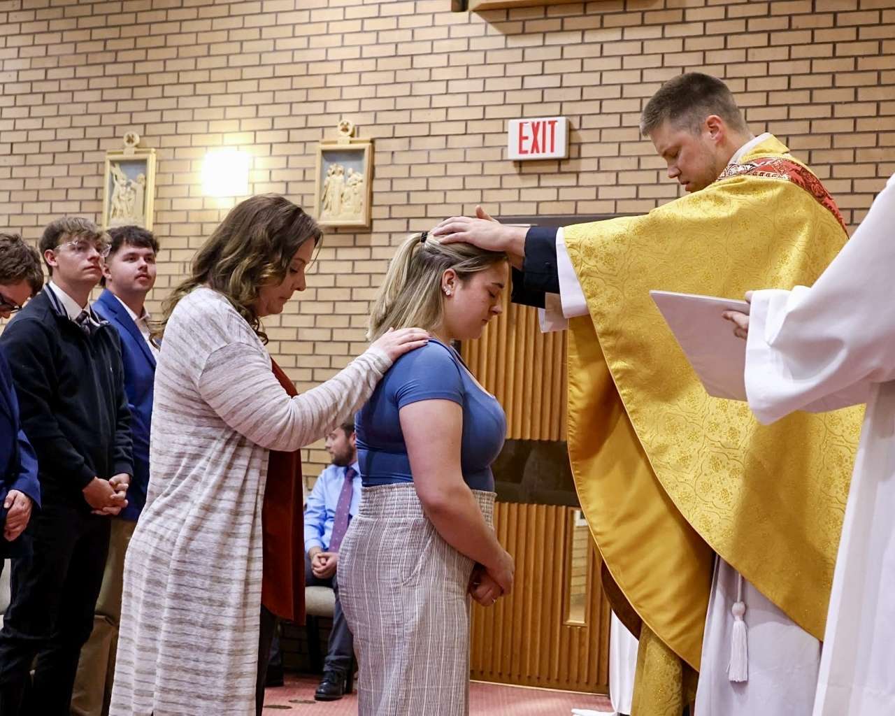 The Rev. Andy Hammeke at the 2026 Easter Vigil Mass. The Comeau Catholic Campus Center celebrated 11 Baptisms, along with 28 individuals receiving the Sacraments of Confirmation and First Holy Communion. Courtesy photo