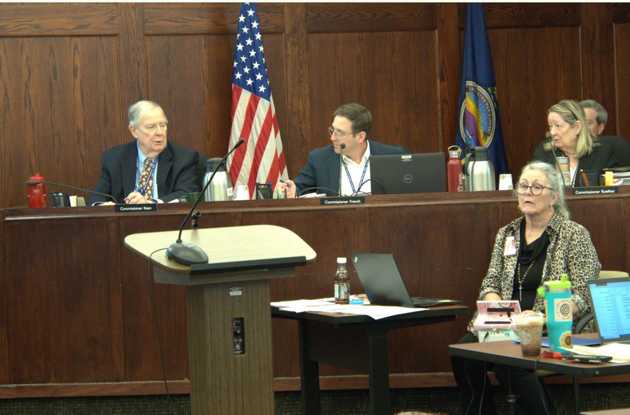  The Kansas Corporation Commission, shown here in a June 2025 hearing, set limits on Evergy's construction of a tranmission line, stopping it from crossing prairie grasslands in south-central Kansas. The KCC approved just part of the line's construction at its May 12, 2026, business meeting, and sent the company back to the drawing board for a portion of the line. (Morgan Chilson/Kansas Reflector)