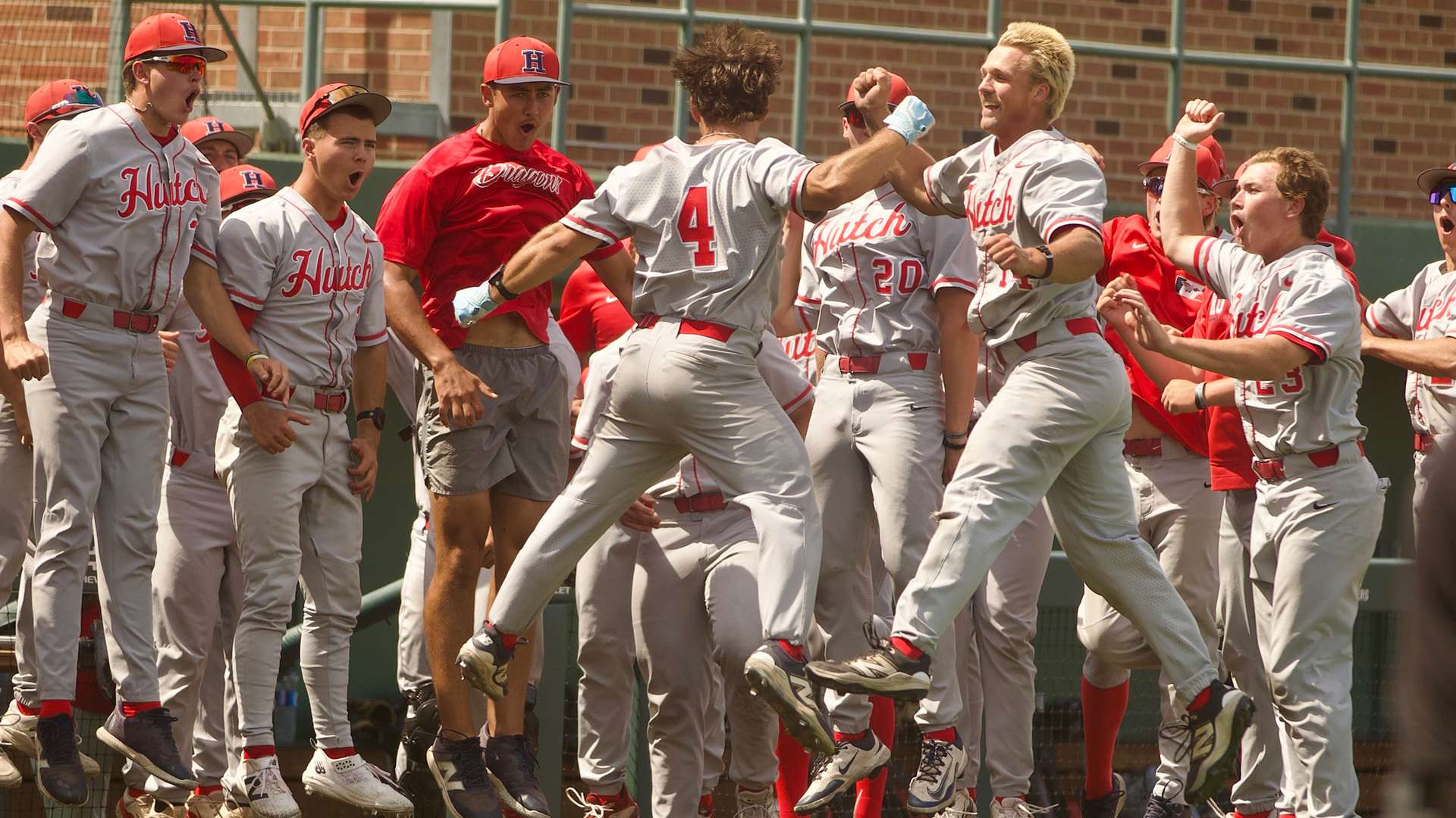 Eli Duncan (4) celebrates with teammates after hitting a two-run home run in the seventh inning of the Blue Dragons' 18-10 victory over Seward County in a first-round elimination game of the Plains District Tournament on Thursday at Eck Stadium in Wichita. (Sydney Holzrichter/Blue Dragon Sports Information)