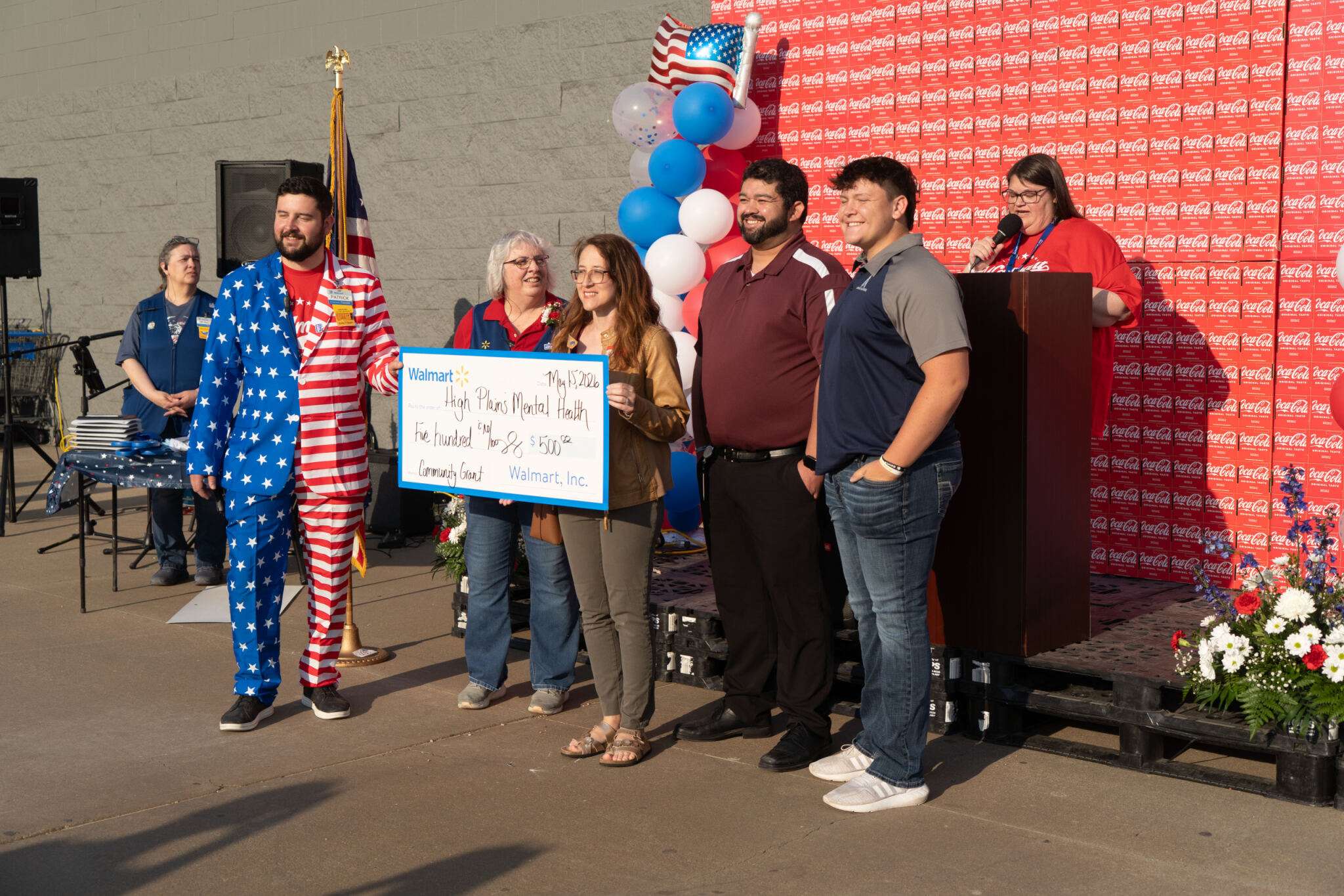 High Plains Mental Health Center representatives and Thomas More Prep-Marian Senior Braden Gilmore accepting a Walmart donation.&nbsp;Photo by Leigh Purdy/Chamber in Hays