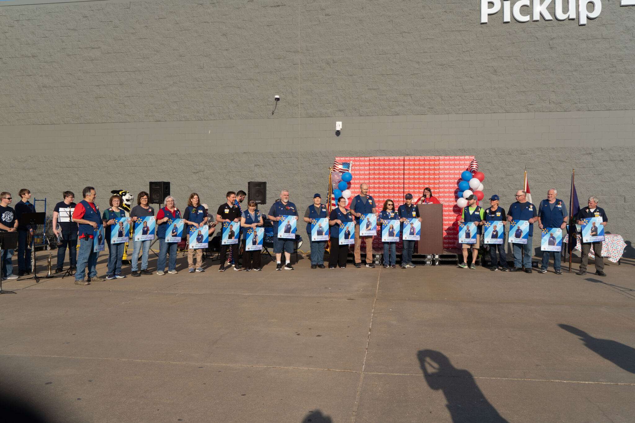 More than a dozen employees were recognized at the Walmart grand-reopening celebration.&nbsp;Photo by Leigh Purdy/Chamber in Hays