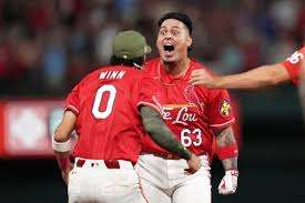 St. Louis Cardinals' Yohel Pozo (63) is congratulated by teammate Masyn Winn (0) after hitting a walk-off single to defeat the Kansas City Royals during the 11th inning of a baseball game Friday, May 15, 2026, in St. Louis. (AP Photo/Jeff Roberson)