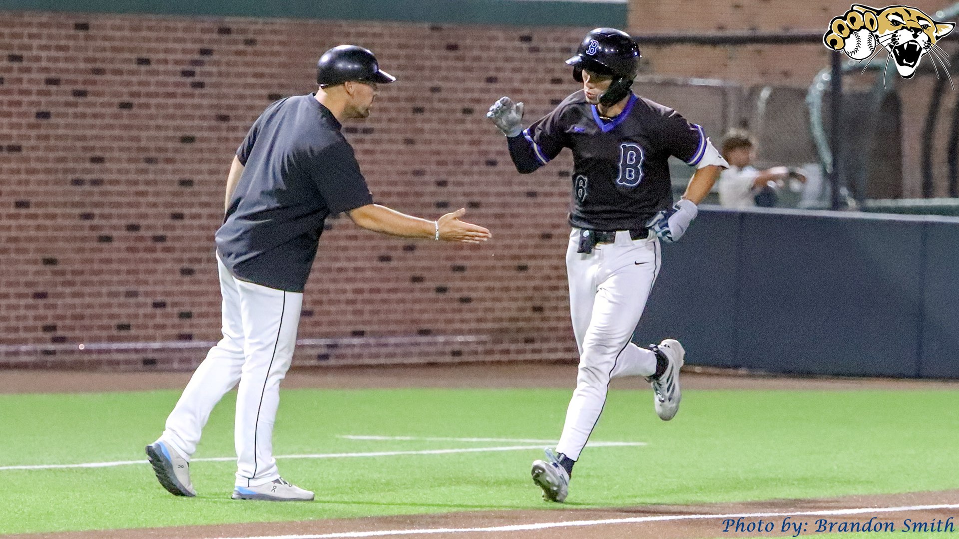  JJ Spafford celebrates with Head Coach Brent Biggs after 8th inning go-ahead homer against No. 1-ranked Johnson County (May 15, 2026) (BartonSports.com)