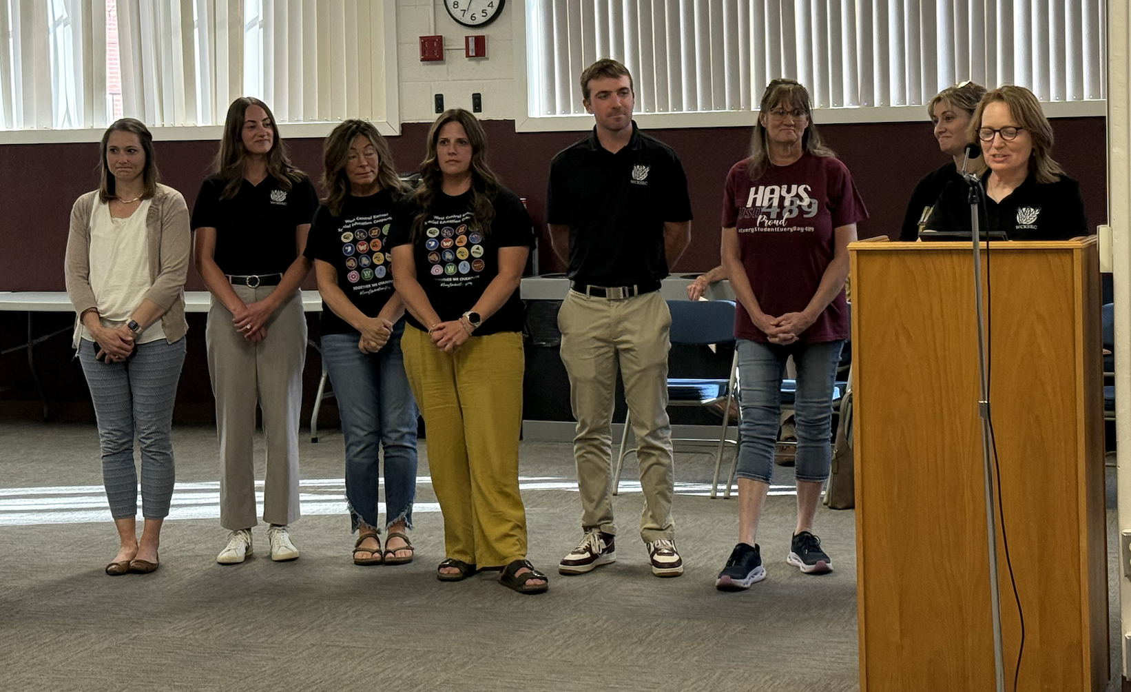 School psychologists, including Julie Zollinger, at podium, recognize Kyle Carlin for his service to the special education cooperative at a school board meeting on May 12. Photo by Cristina Janney/Hays Post