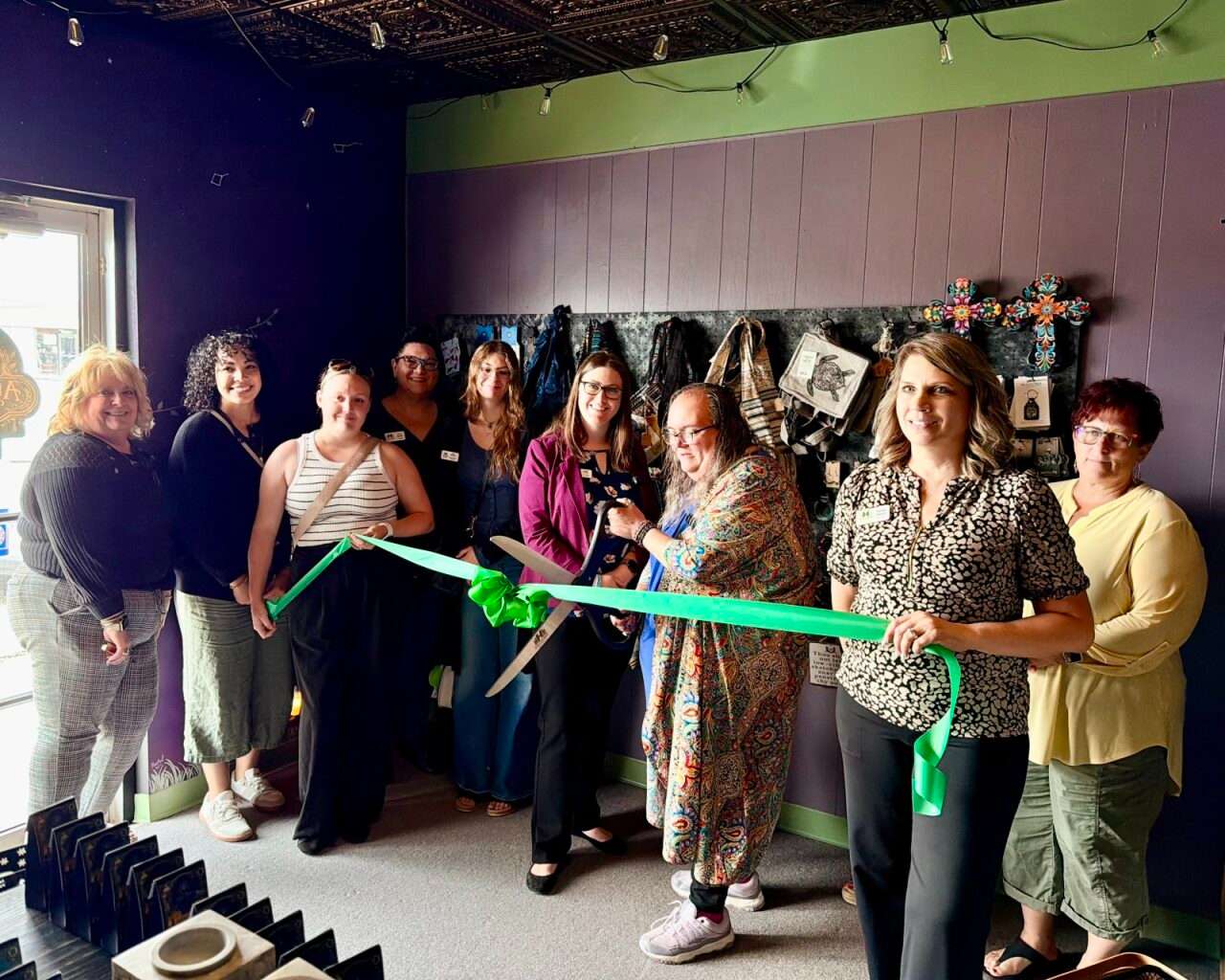 Amy Wierenga, owner of Alternative Reflection, cutting a ribbon at the grand opening of her new store in Hays. Photo by Tony Guerrero/Hays Post