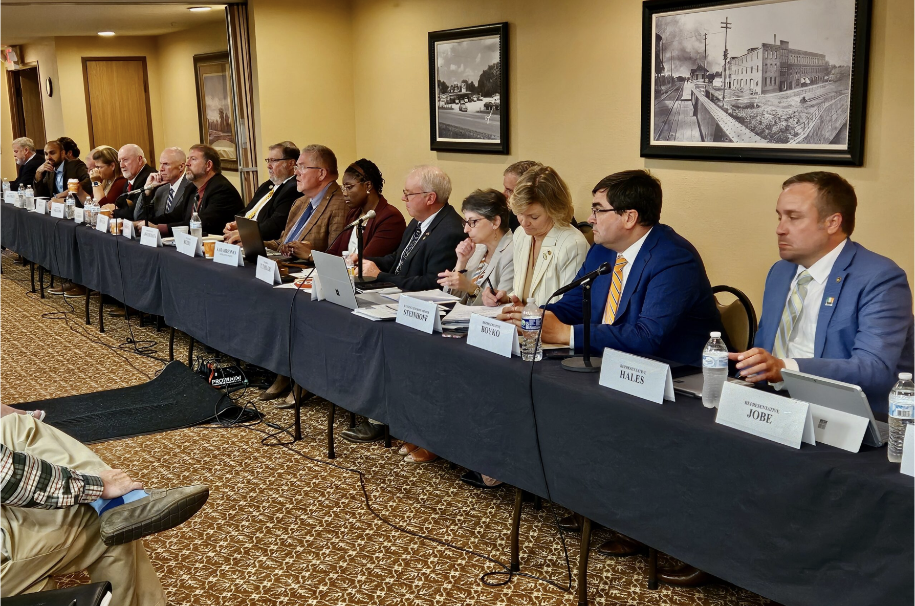 Members of the House Special Interim Committee on Property Tax Reform, chaired by state Rep. Tim Taylor, fifth from right, listen to testimony at a hearing Aug. 27 in Macon (Rudi Keller/Missouri Independent).
