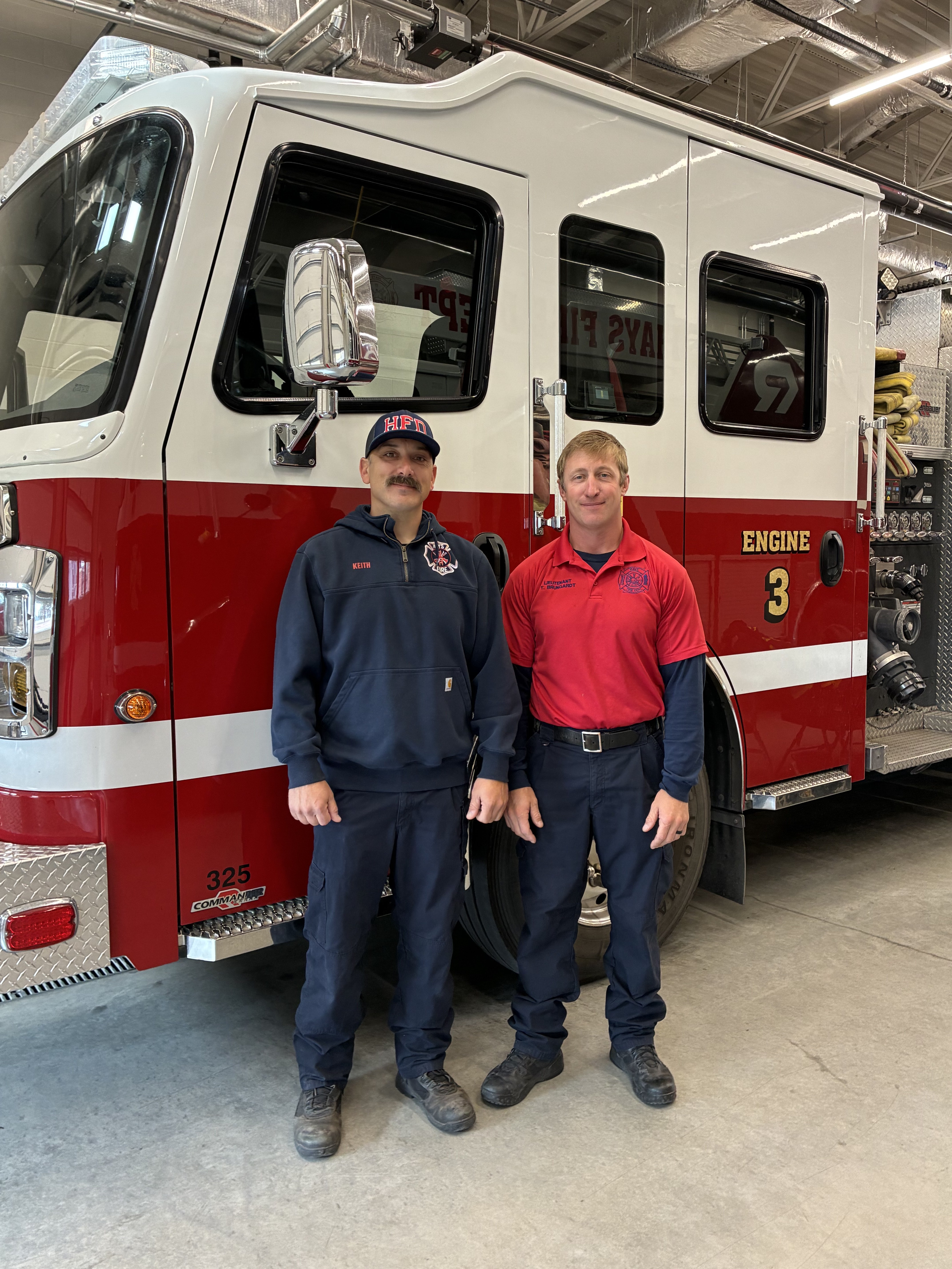 Hays Firefighter Grady Keith (left) and Hays Fire Lieutenant Tyler Brungardt (right) pictured in front of Fire engine three at the Hays Fire Department. Photo by Alin Hett/Hays Post
