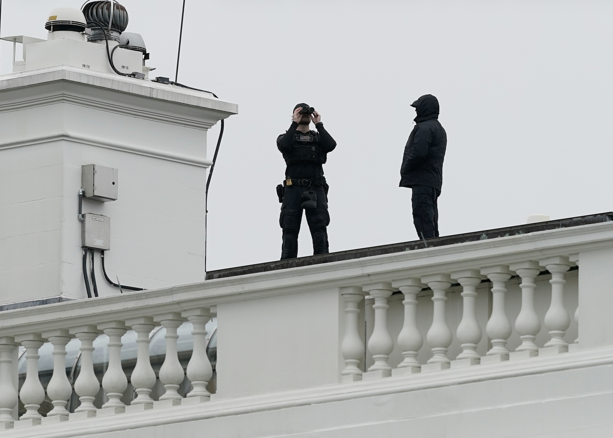 U.S. Secret Service Police observe from the roof of the White House, Saturday, May 23, 2026, in Washington, after reports of shots fired near the White House. (AP Photo/Jose Luis Magana)