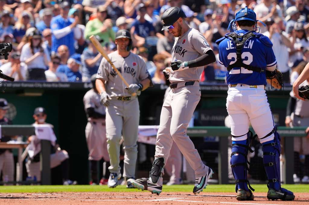 New York Yankees left fielder Cody Bellinger, center, runs home to score after hitting a solo home run during the second inning of baseball game against the Kansas City Royals, Monday, May 25, 2026, in Kansas City, Mo. (AP Photo/Charlie Riedel