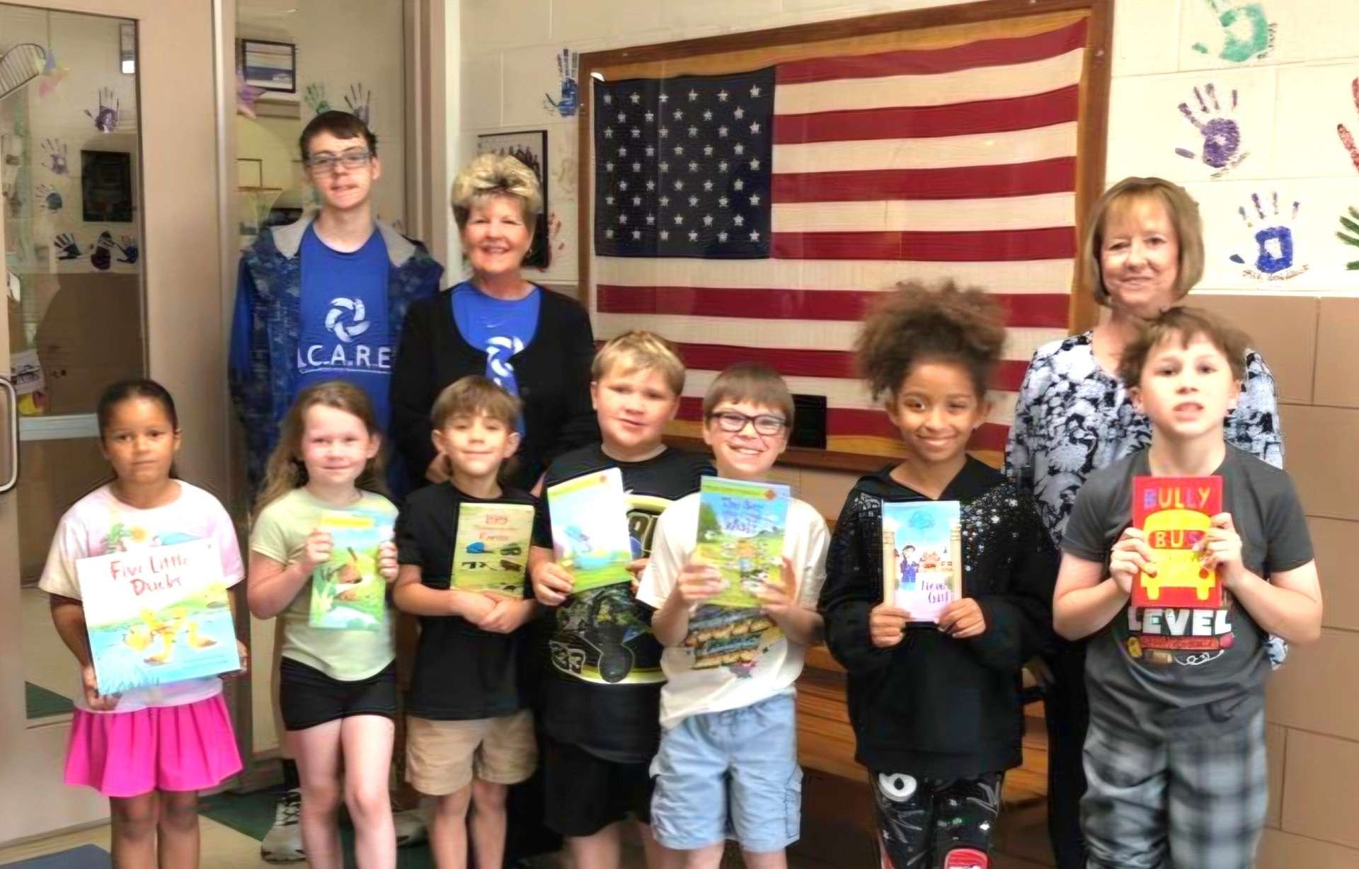A photo of the most improved readers in Kindergarten through 5th grade at Milford School. Pictured are the students along with Principal Phyllis Boller and I.C.A.R.E. Board Members Sean Mueller and Wendy King-Luttman.