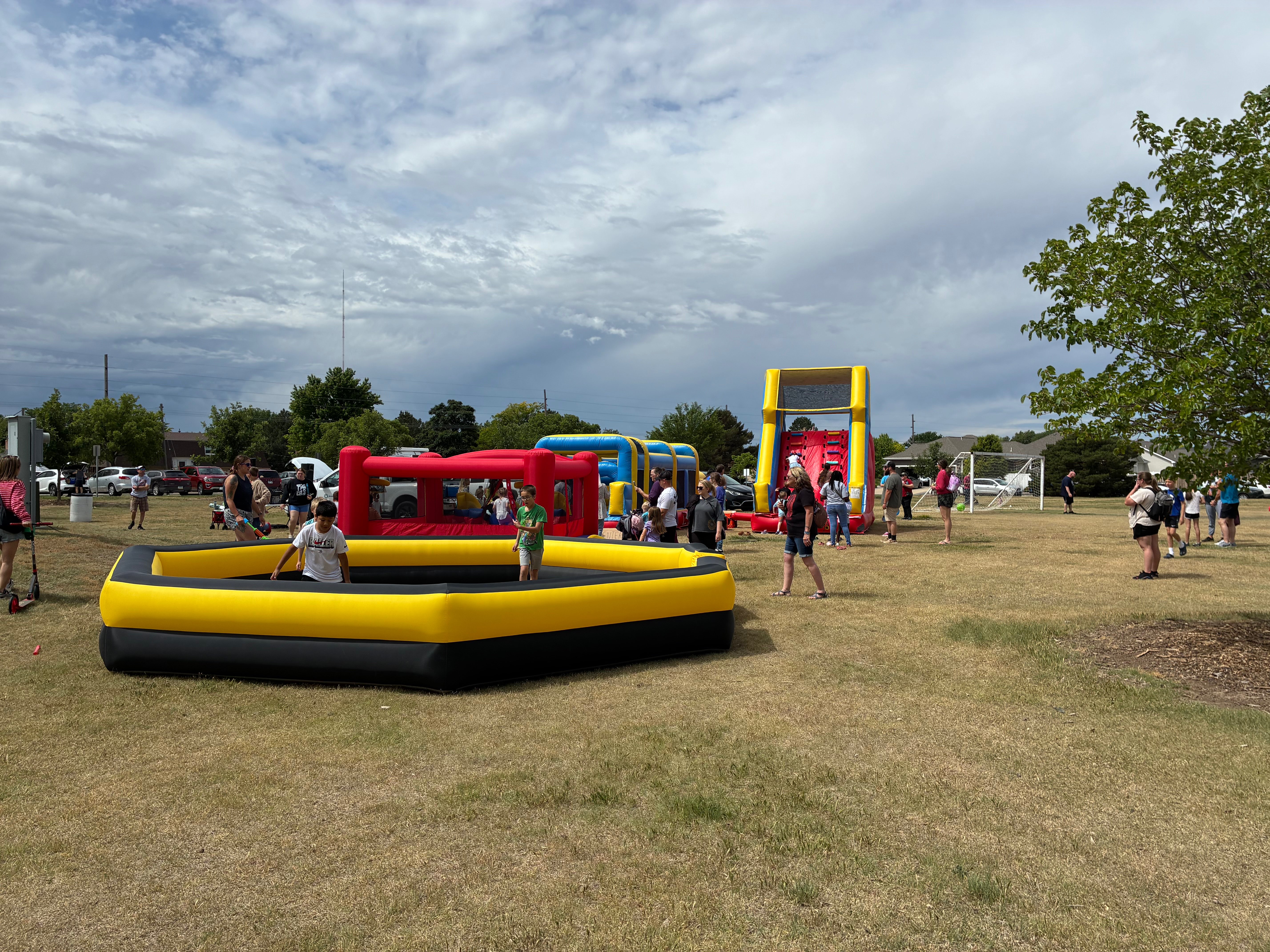Children spend the afternoon playing on inflatable slides and bouncy houses during the second-annual Picnic in the Parc, one of several family-friendly attractions featured at the event. Photo by Alin Hett/ Hays Post<br>