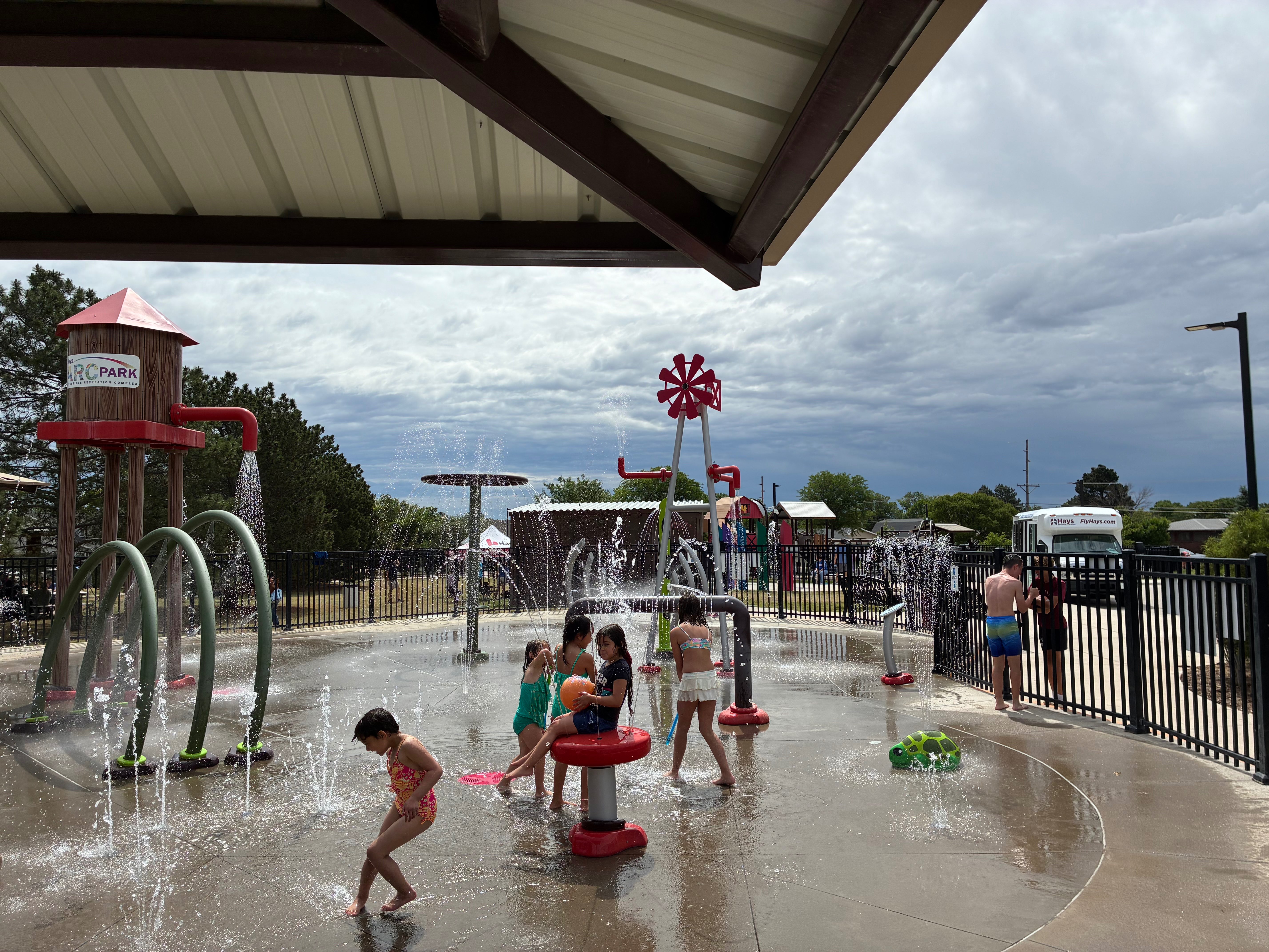 Children cool off and splash in the water as families enjoyed the warm summer afternoon festivities. Photo by Alin Hett/ Hays Post<br>