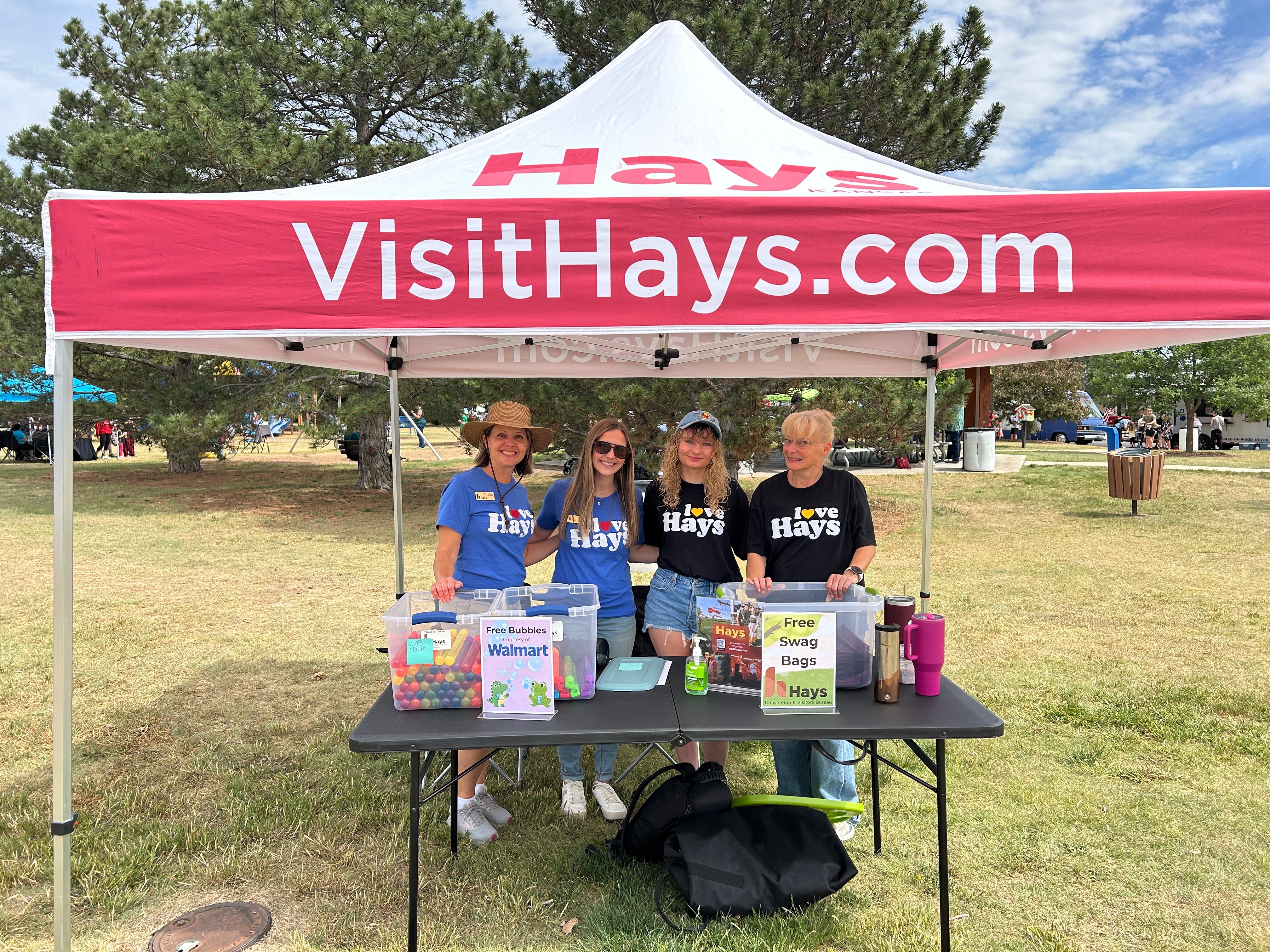 Hays Convention and Visitors Bureau staff including executive director Melissa Dixon, left, pose for a picture underneath their tent at Picnic in the Parc. Photo courtesy of Hays CVB. 