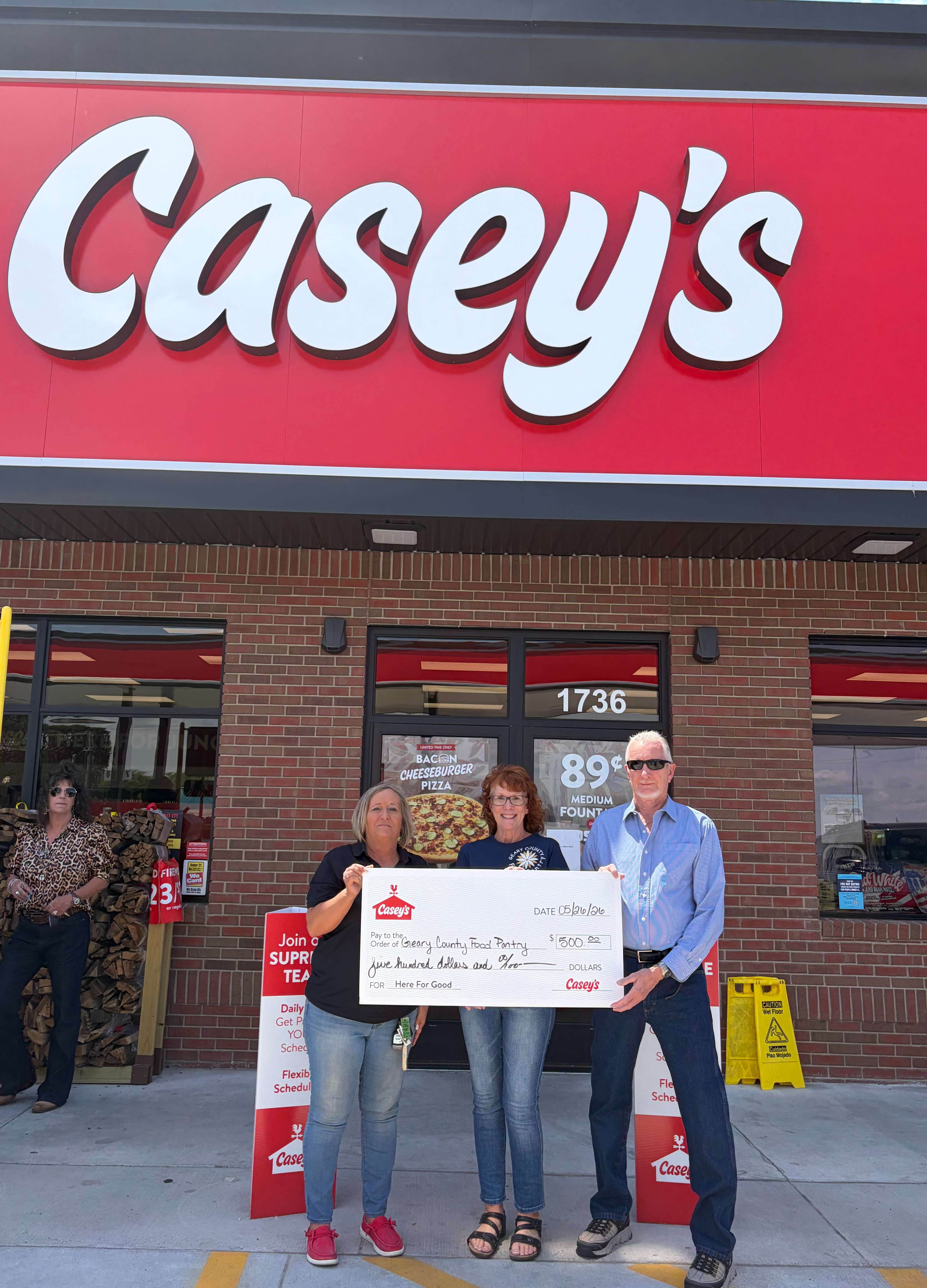 Casey's General Store District Manager Ann Mitchell presents a $500 check to Stephanie Diehl (President of the Board - Geary County Food Pantry), and Bob Marsh (Warehouse Manager - Geary County Food Pantry).