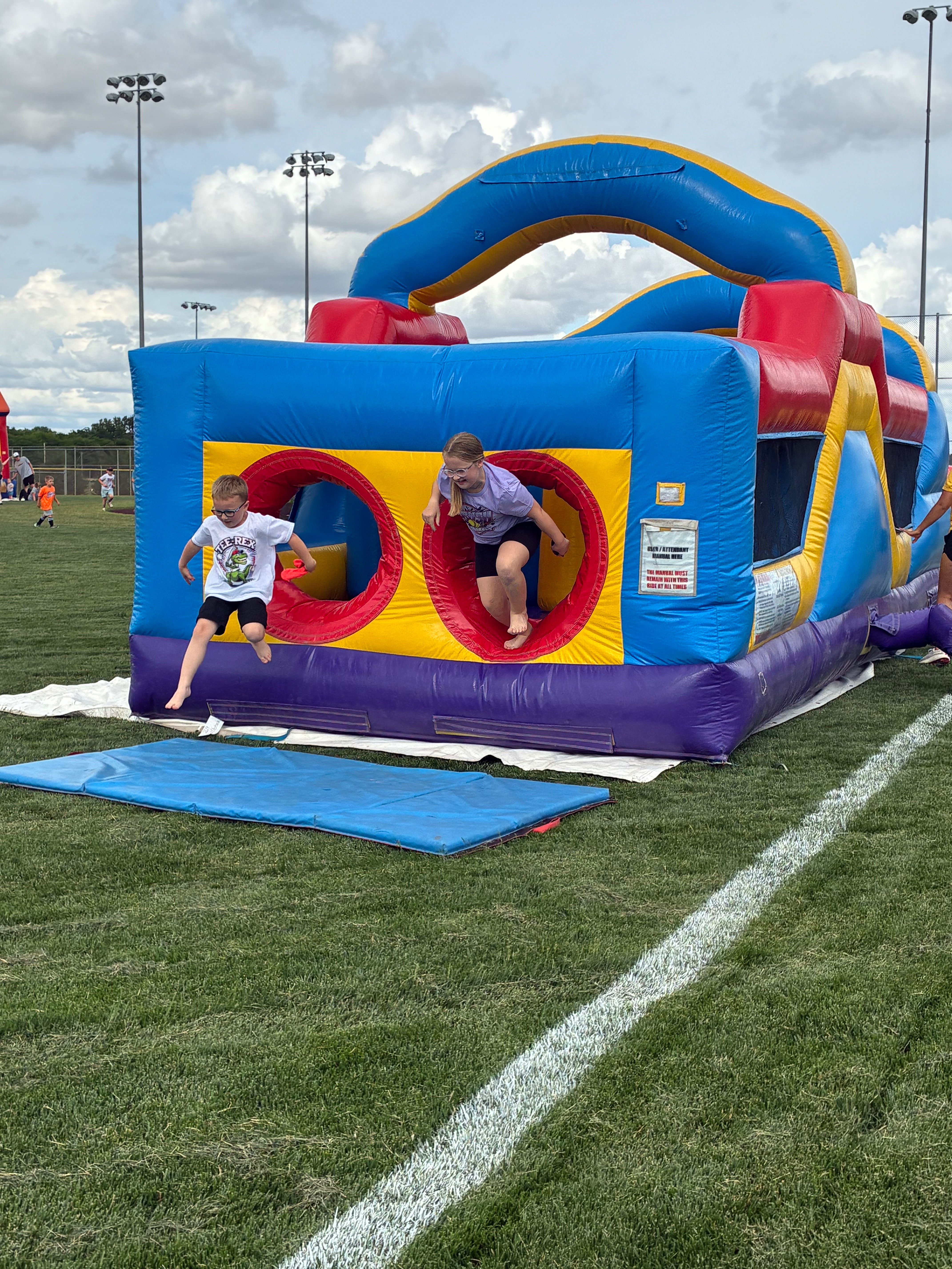 Children playing in one of three bouncy houses set up during Hays Recreation opening day. Photo by Alin Hett/Hays Post. 
