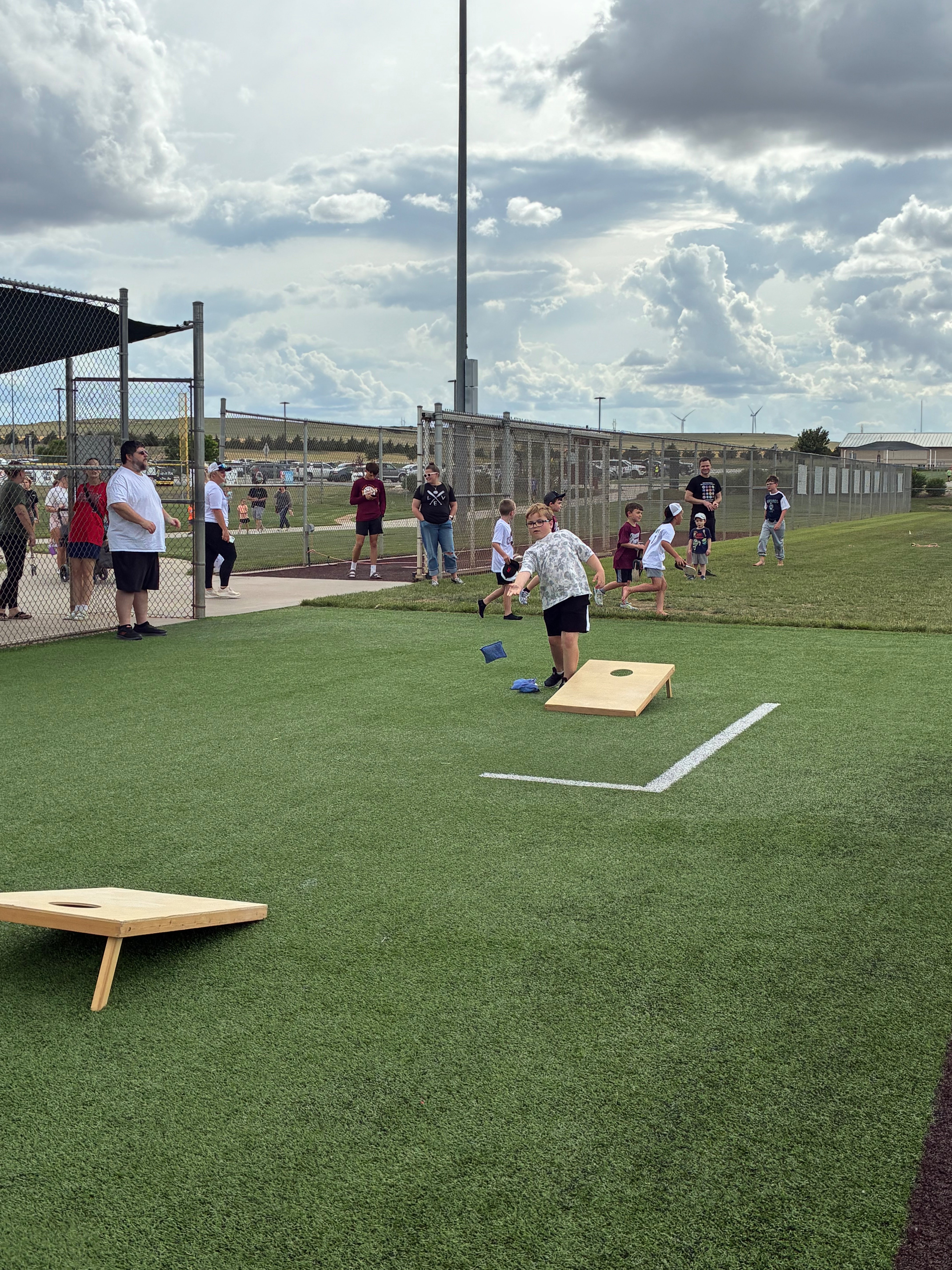 Kids playing corn hole during Hays Rec Opening Day. Photo by Alin Hett/Hays Post. 