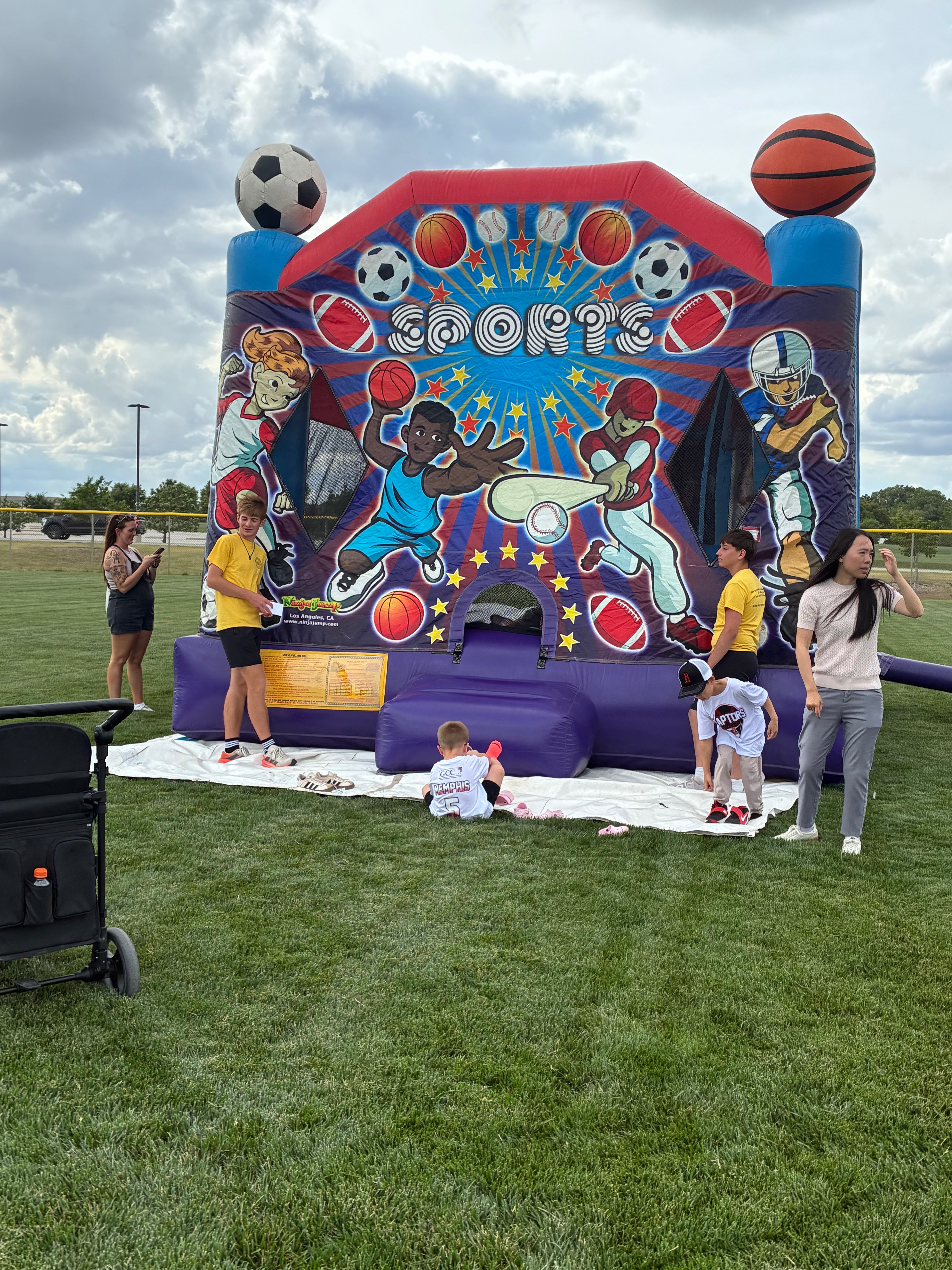 Children taking off their shoes getting ready to go into one of three bounce houses. Photo by Alin Hett/Hays Post. 