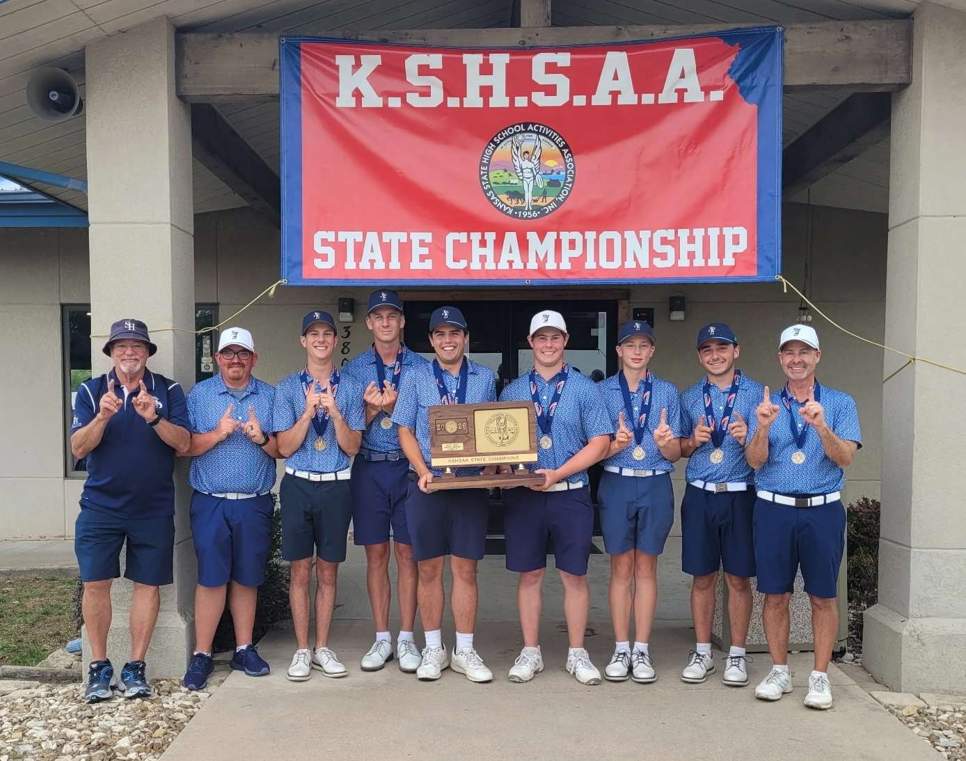 The Sacred Heart golf team proudly poses with their state trophy after winning an 11th-straight state title.
