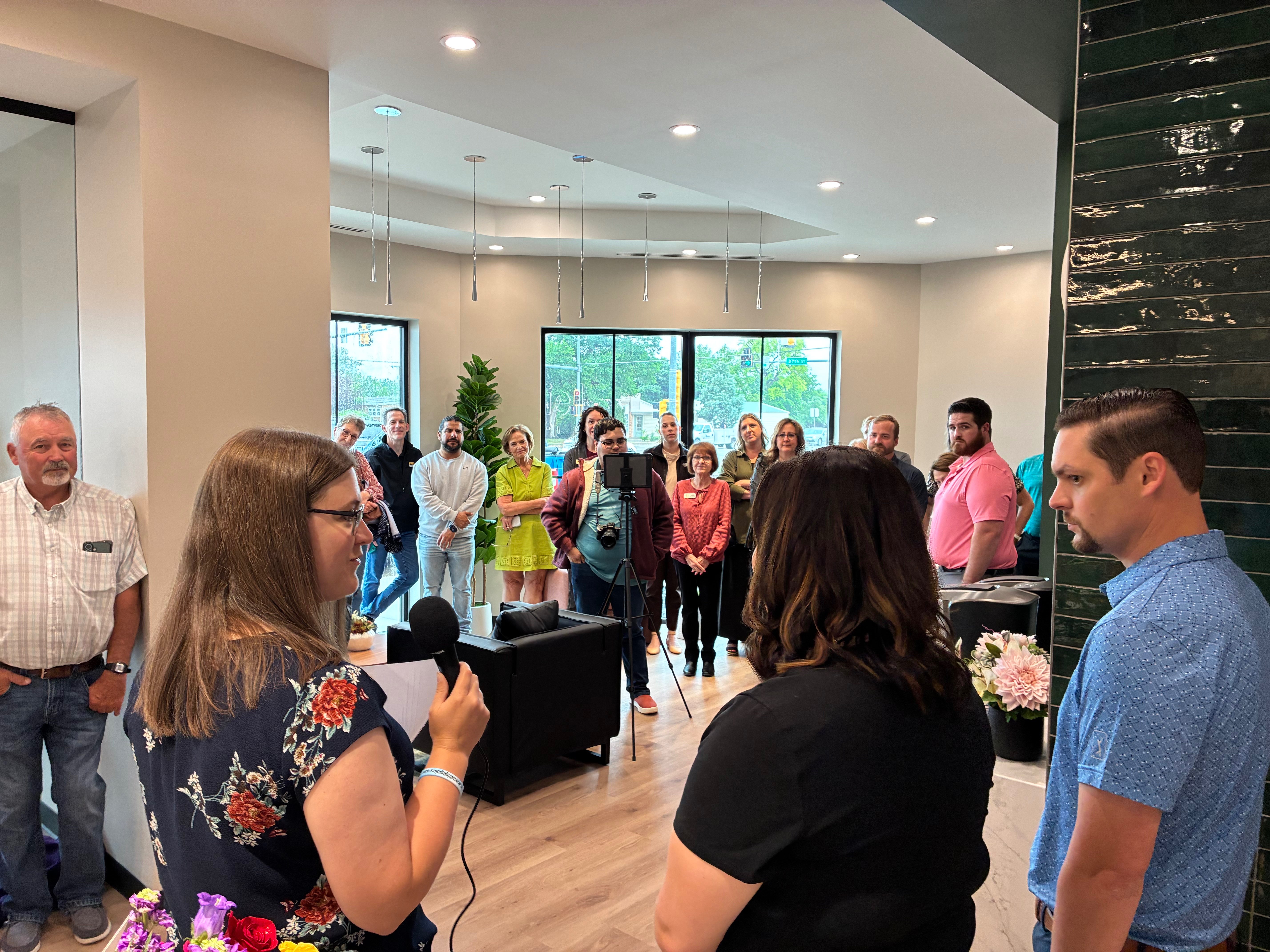 Vice President of Membership for the&nbsp; Chamber in Hays, Leigh Purdy, left, Alexyss Leiker, dentist, middle, and Austin Werth, right, visit with attendees during the opening celebration for Leiker Smiles.<br>