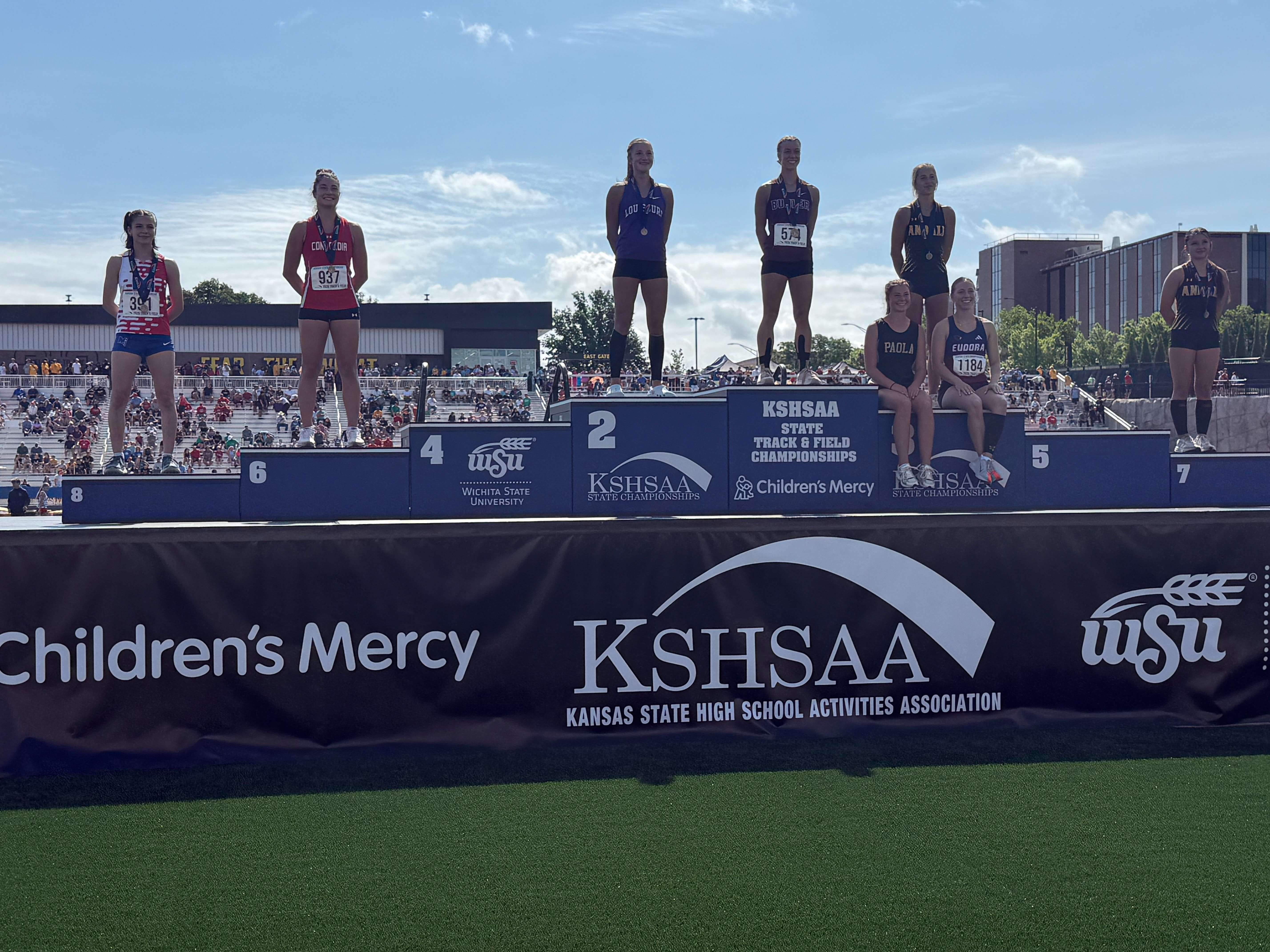 Buhler's Jenna Lackey on the award podium after claiming the Class 4A pole vault championship.