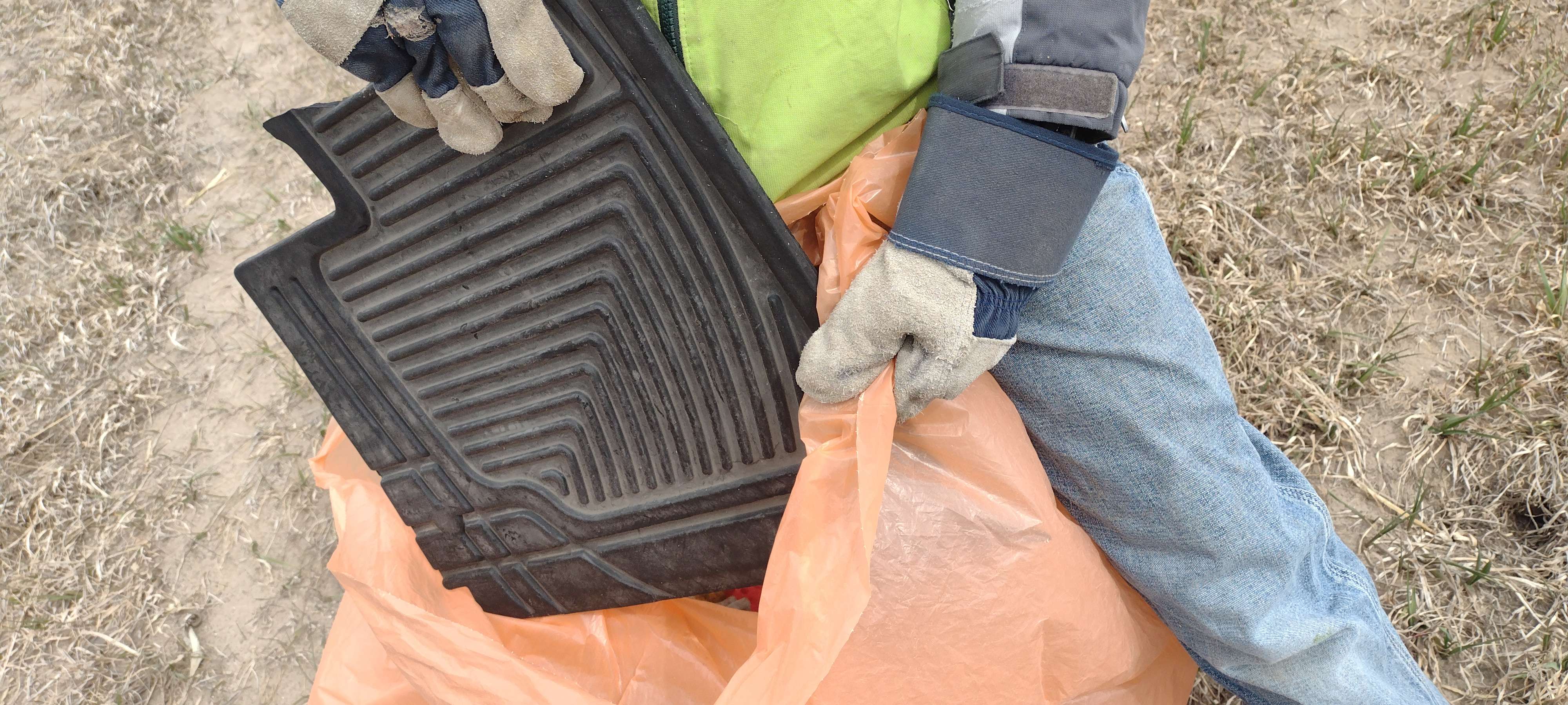 A youth volunteer bags a wayward floor mat during the recent Knights of Columbus highway cleanup north of Alliance.