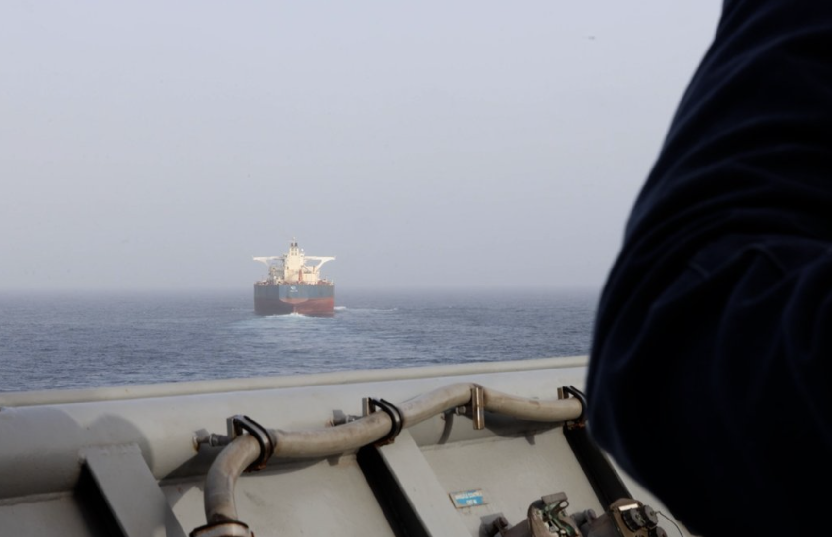 FILE photo A U.S. Sailor aboard USS Comstock (LSD 45) observes a commercial vessel while enforcing the U.S. blockade against Iran, May 21. U.S. forces have redirected 97 commercial vessels and disabled 4 since the start of the blockade. File photo U.S. Central Command
