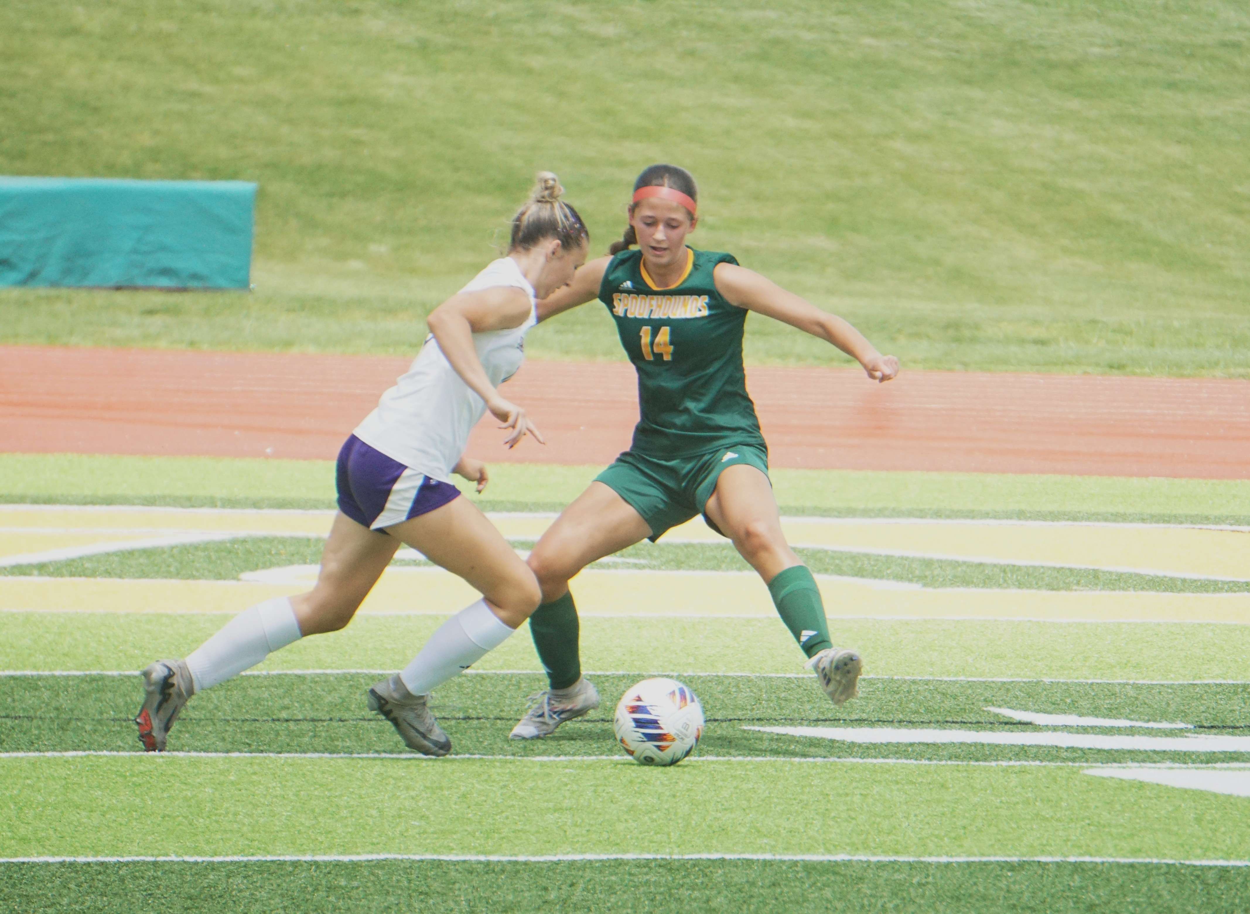Pleasant Hill's Adyson Elliott (13) attempts to dribble around Maryville defender Julia Branner (14)/ Photo by Matt Pike