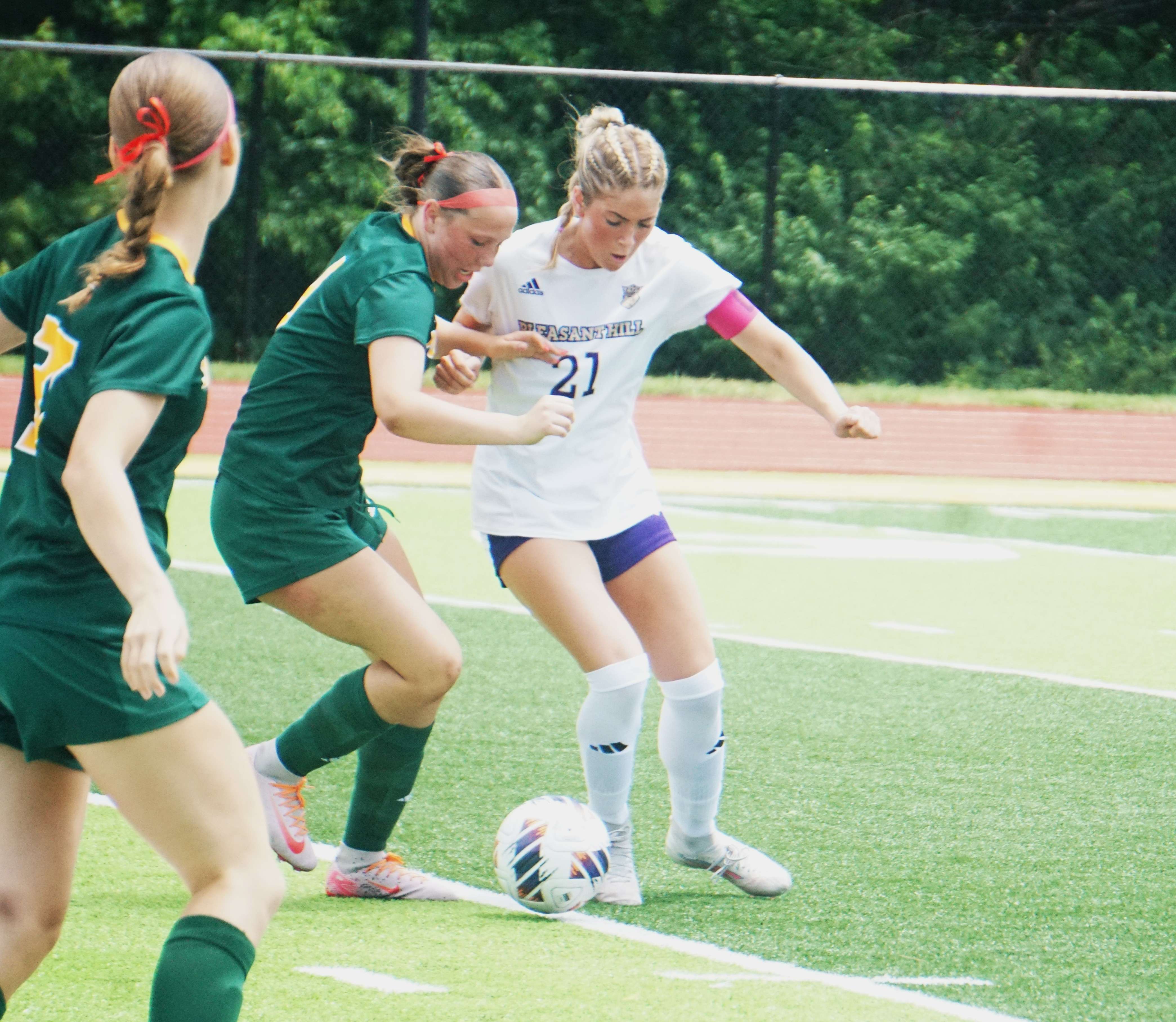 Pleasant Hill's Natalie Ward (21) holds off a Maryville defender/ Photo by Matt Pike