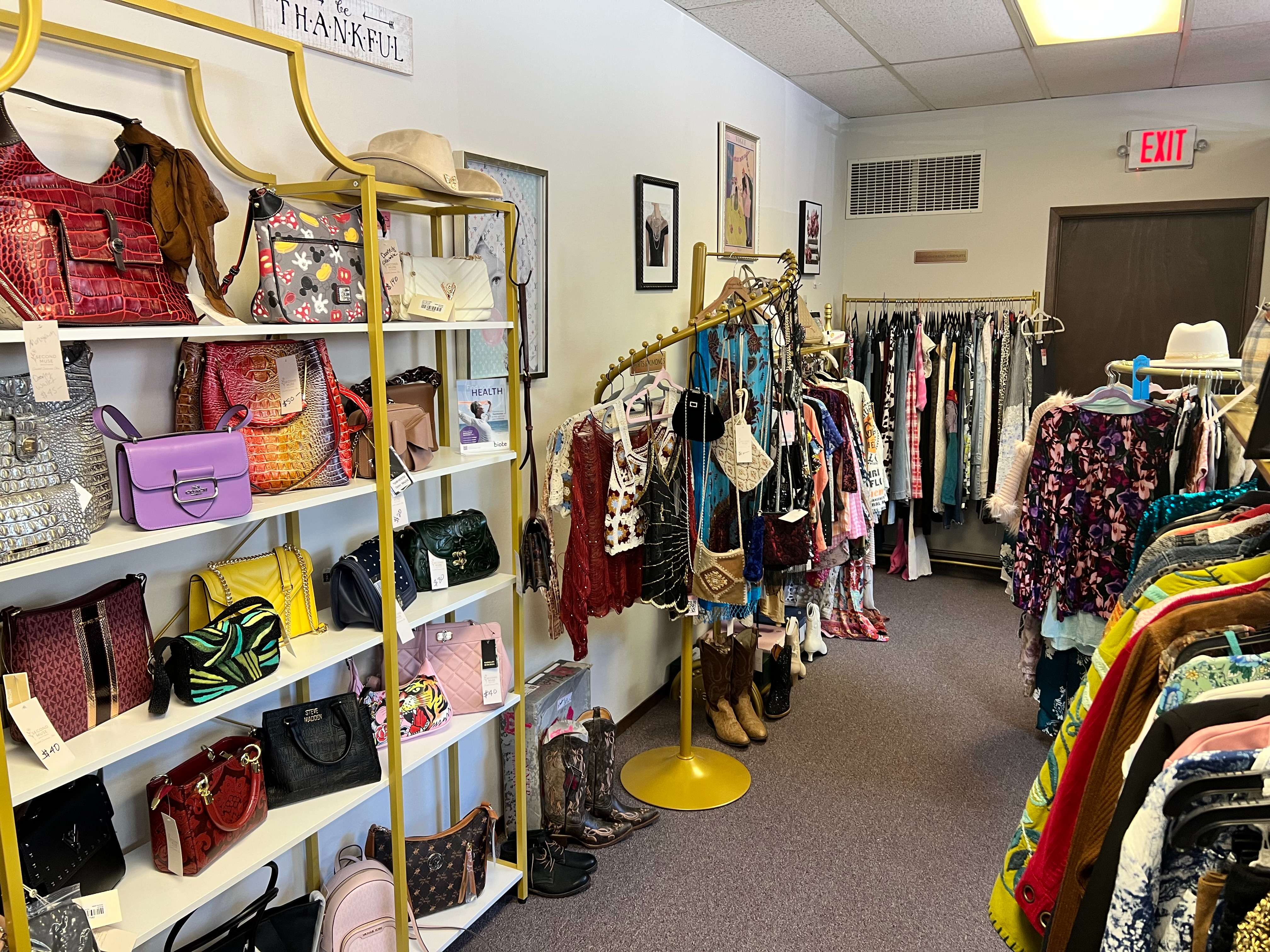 Clothing, handbags and accessories are displayed inside Second Muse Boutique during an open house Friday, May 29, 2026, at 1011 N. Main St. in Hutchinson. The boutique is located inside ARISE Medical & Wellness House and offers a mix of new and pre-owned items. (Hutch Post Photo/Sean Boston)