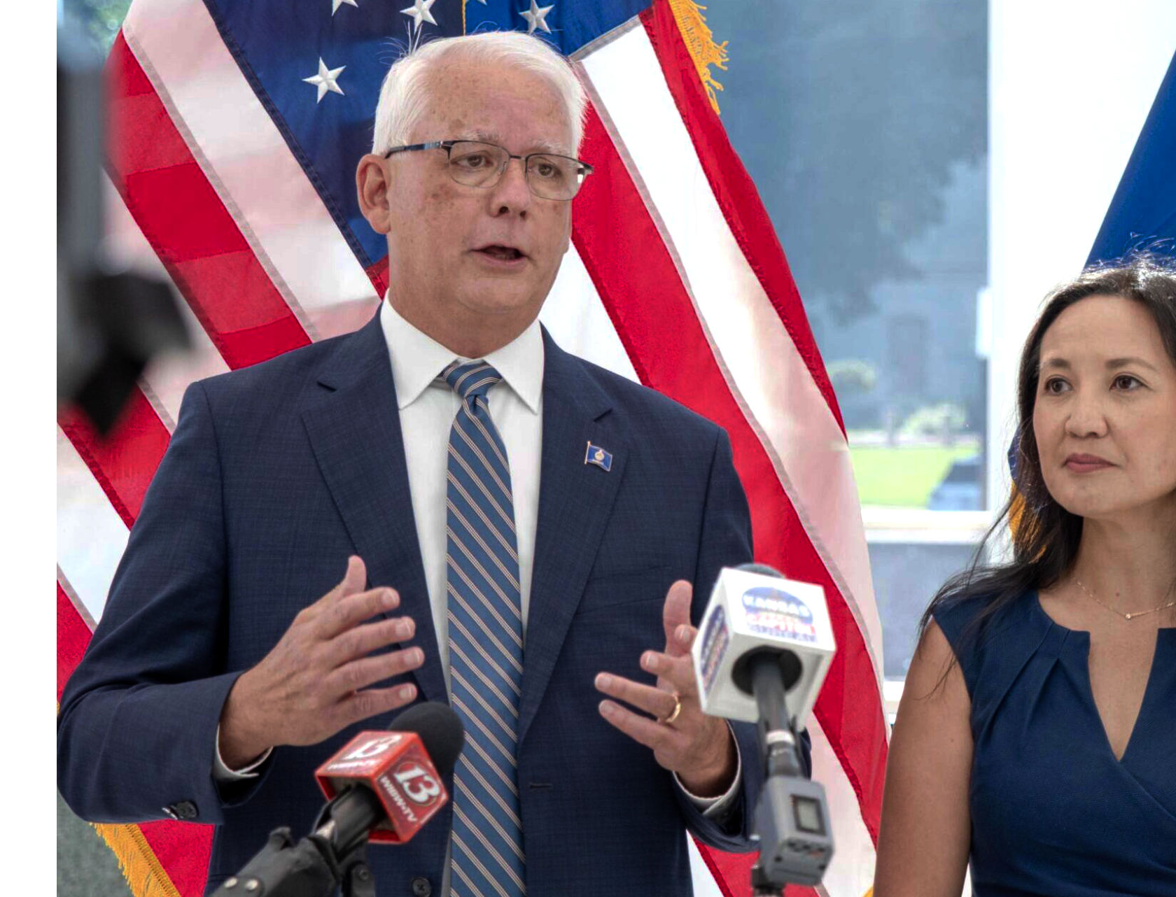 Overland Park Mayor Curt Skoog and Fredonia physician Jennifer Bacani McKenney talk to reporters June 1, 2026, at the Secretary of State’s Office in Topeka after filing as candidates for the Democratic primary for governor. (Photo by Sherman Smith/Kansas Reflector)
