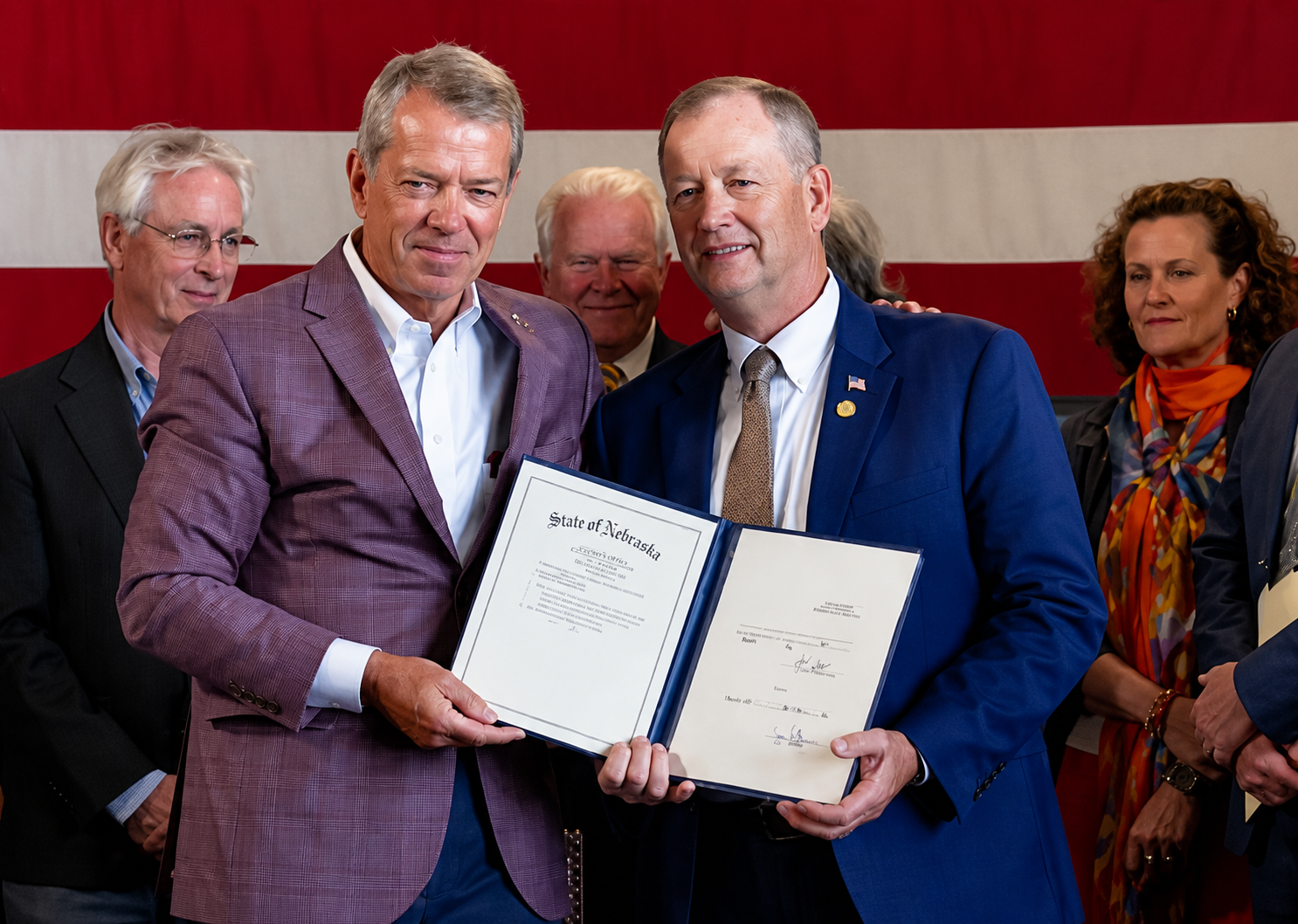 Gov. Jim Pillen, left, participates in a bill-signing ceremony for LB 1261. Supporters say the legislation is designed to help Nebraska meet growing energy demands while protecting existing ratepayers from costs associated with large-scale electrical users. (Press Conference June 2, 2026)&nbsp;