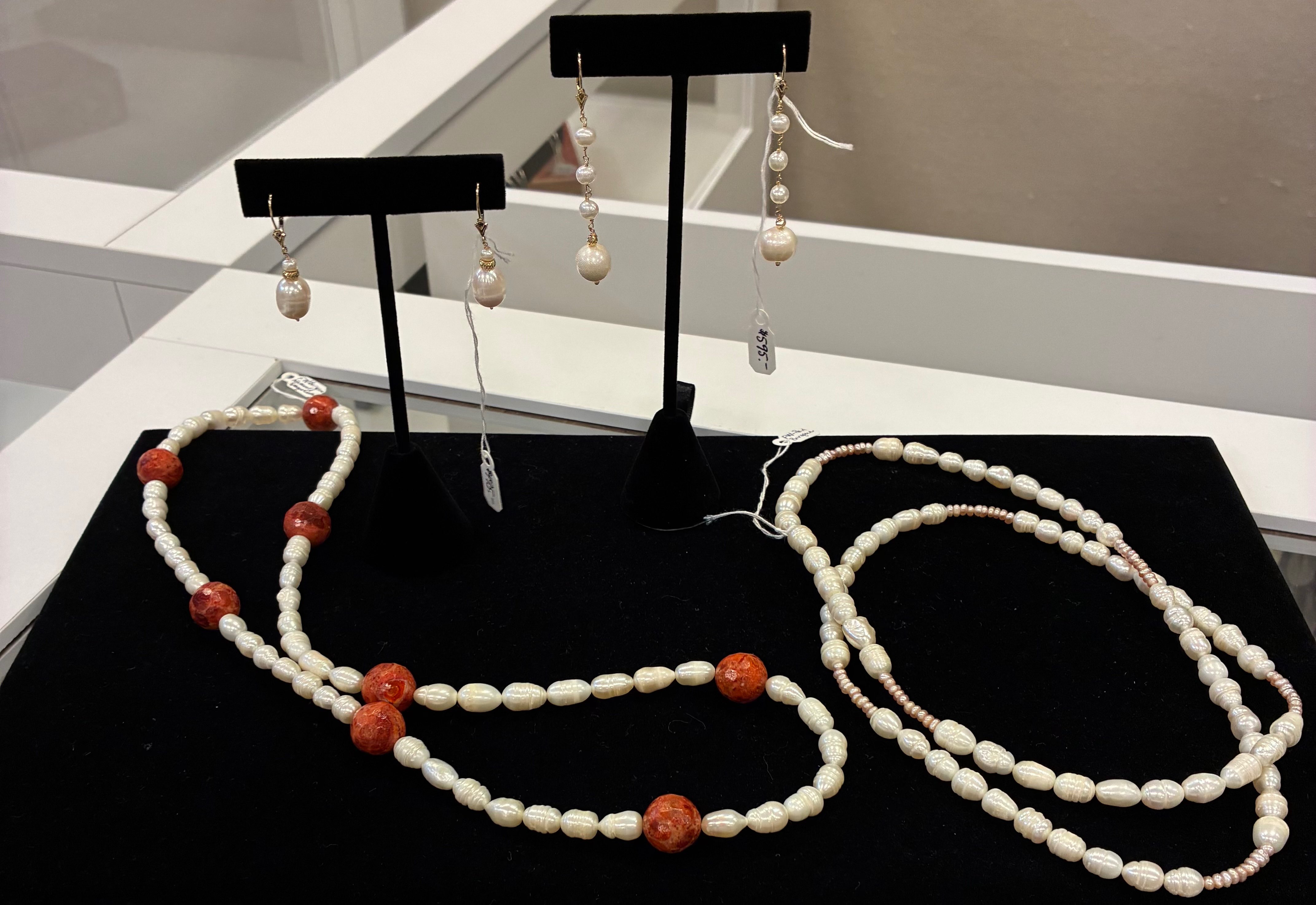 Elegant jewelry pieces displayed in a curated store showcase inside ThyWovenPeacock, Photo by Alin Hett/Hays Post.<br>