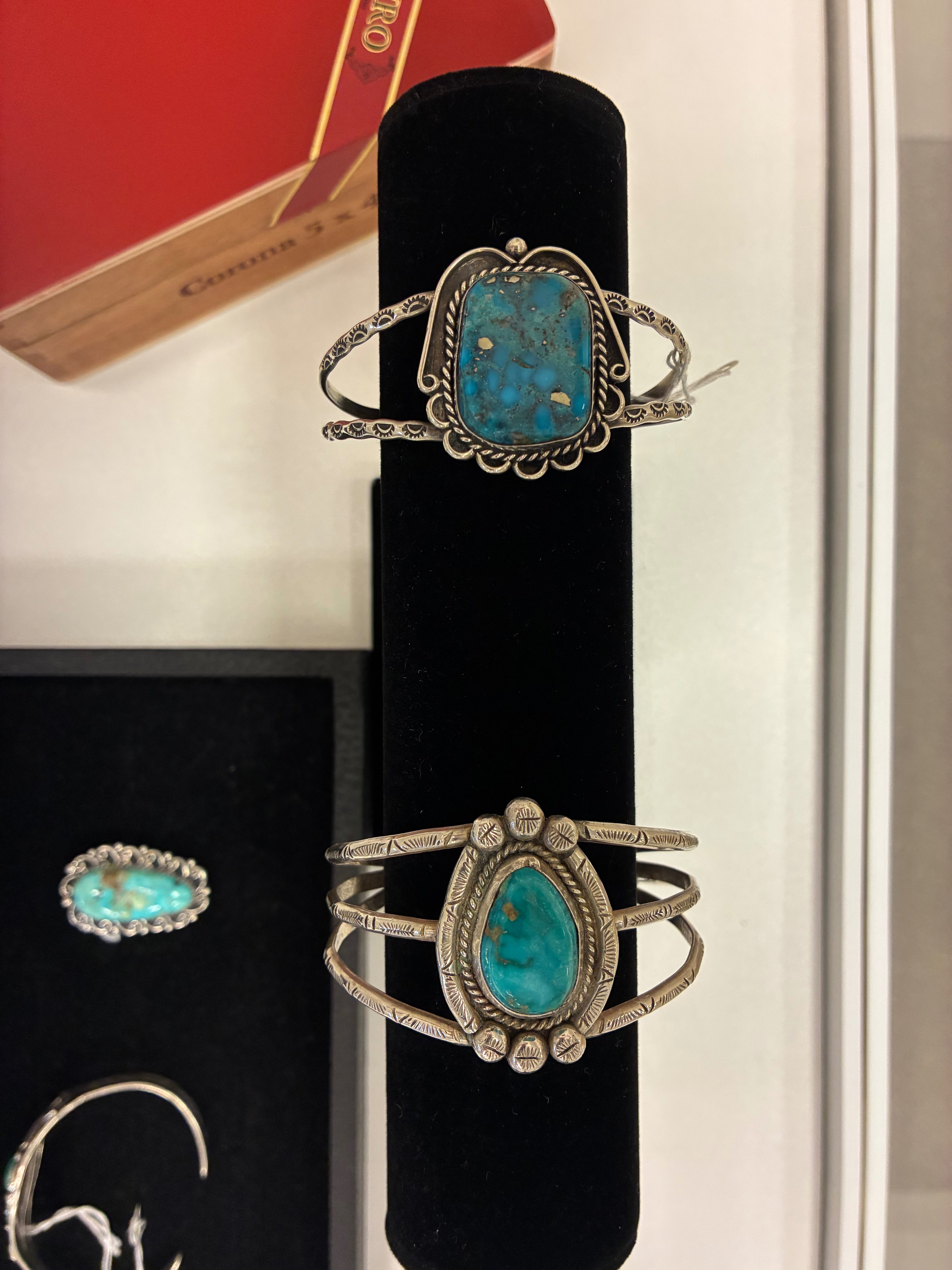 Turquoise jewelry pieces showcasing vibrant blue-green gemstones and intricate metalwork. Photo by Alin Hett/Hays Post.<br>